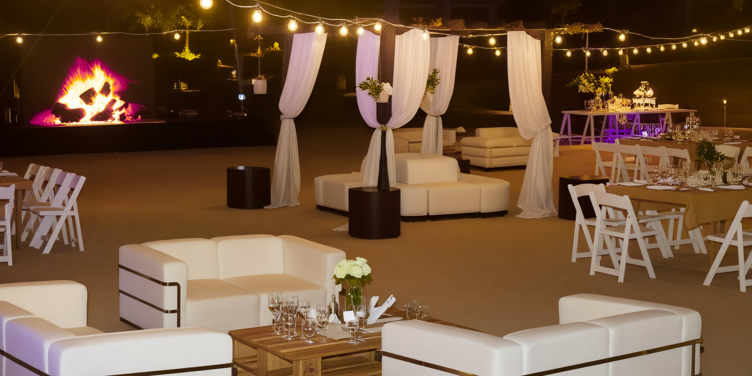 The outdoor event space at Dreams Playa Bonita is perfect for a destination wedding, featuring elegant white furniture, beautifully arranged dining tables, ambient lighting, and a cozy fireplace.