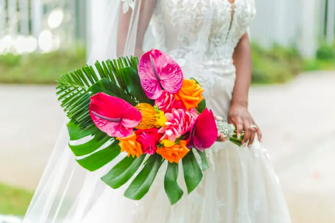 8 spring wedding bouquets that'll dazzle the beach aisle destination weddings monstera leaf bouquet