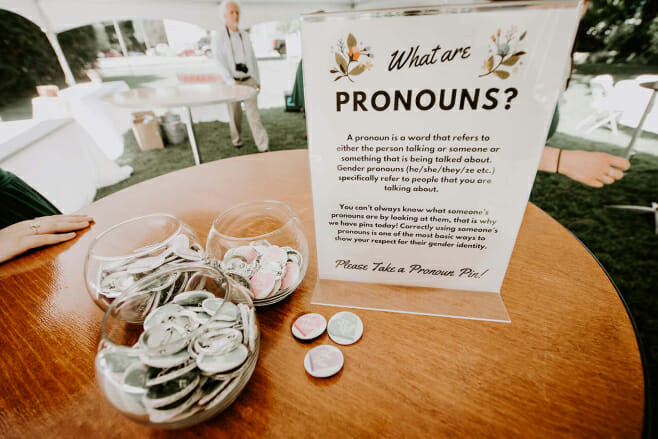 ways to make destination weddings more gender inclusive pronouns place cards pins lgbtq