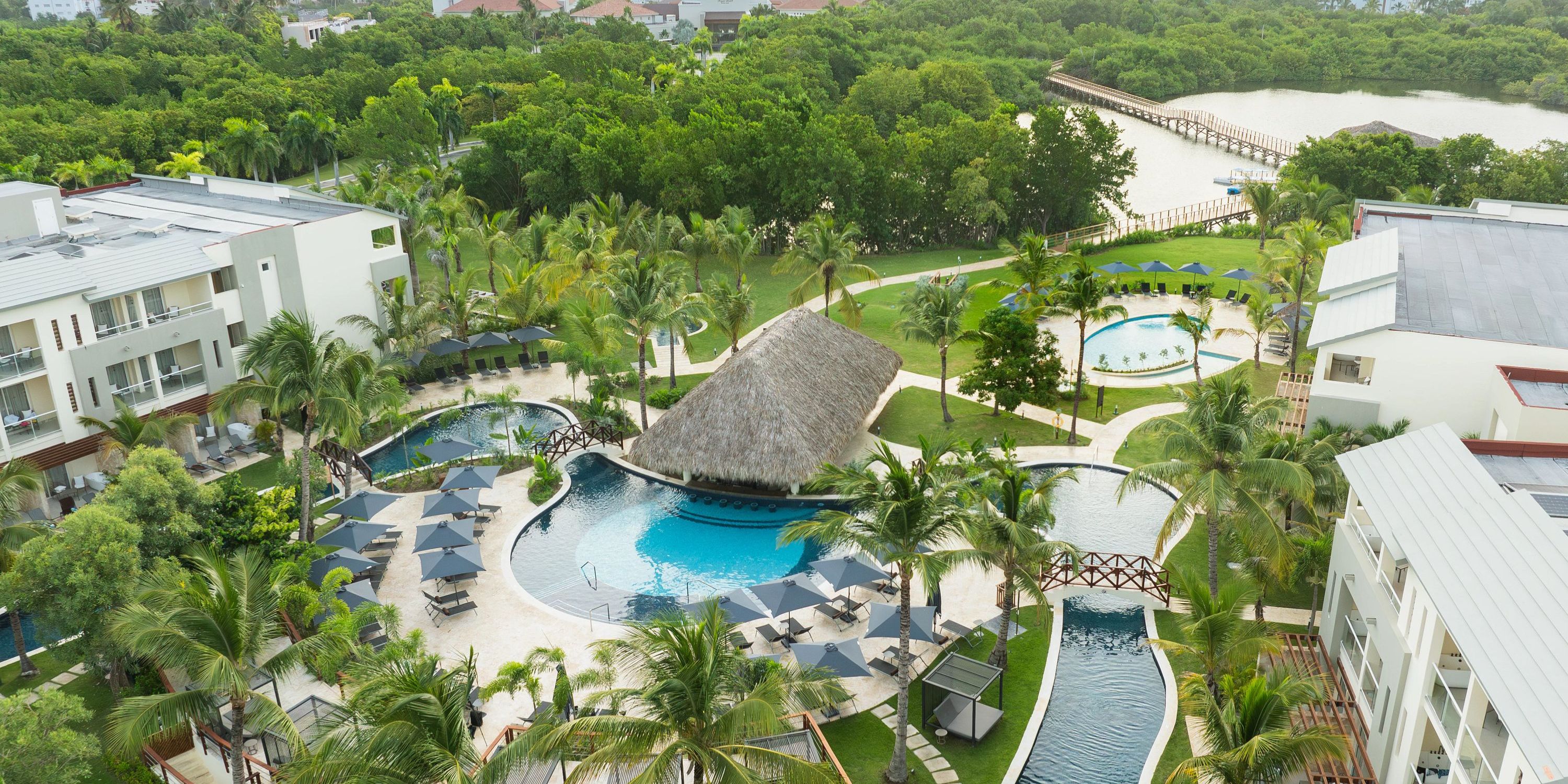 Aerial view of Dreams Royal Beach Punta Cana, a dreamy destination wedding spot with pools, palms, and huts.