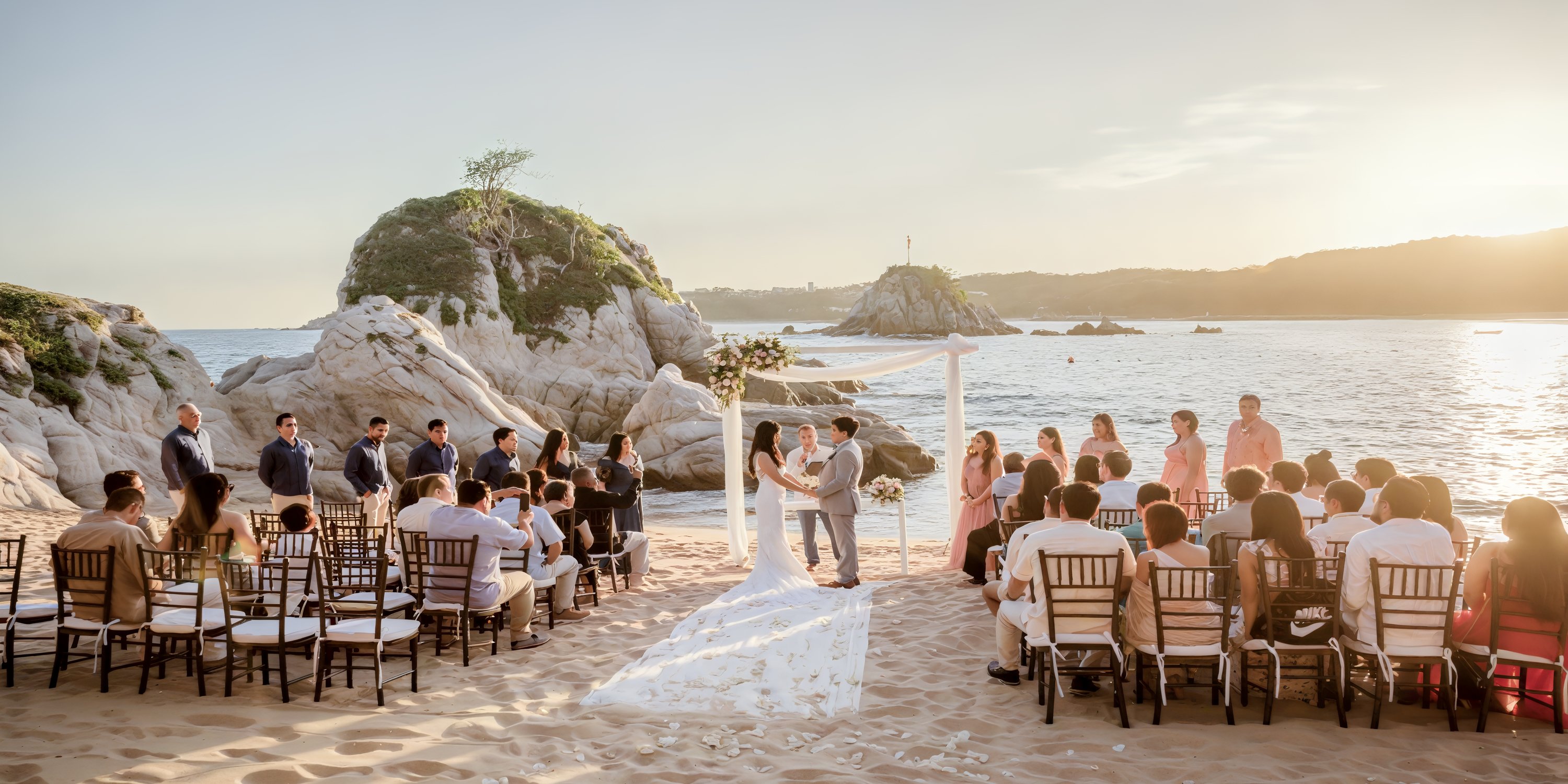 A destination wedding at Dreams Huatulco beach, with guests watching the couple wed at sunset.