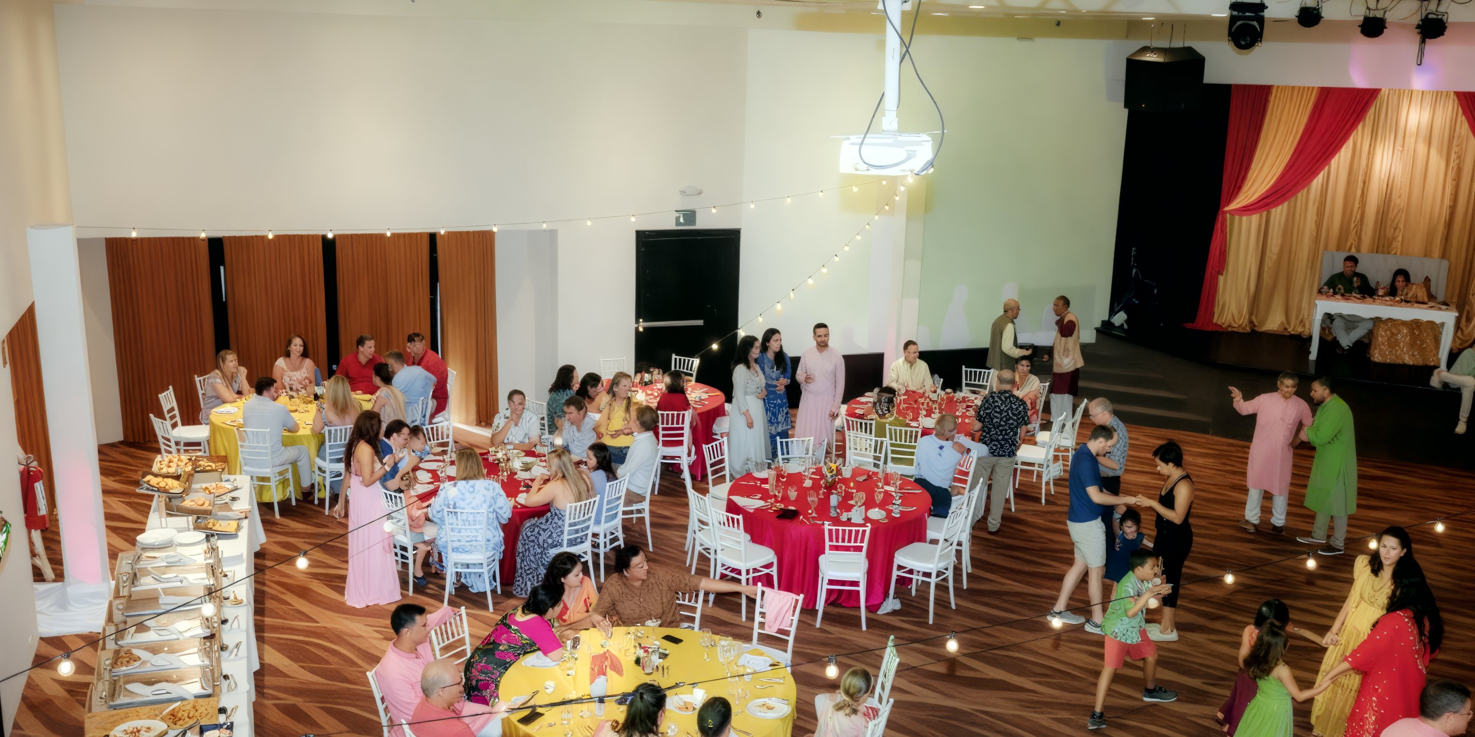 Guests enjoy a festive atmosphere at decorated tables during a destination wedding at Dreams Aventuras.