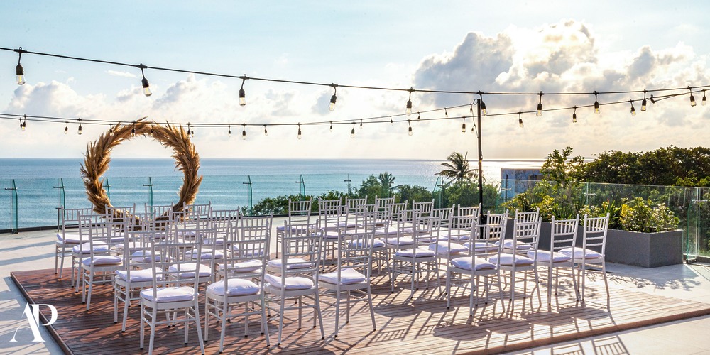 White chairs face a circular wedding arch on the Dreams Bahia Mita rooftop, ideal for a destination wedding.