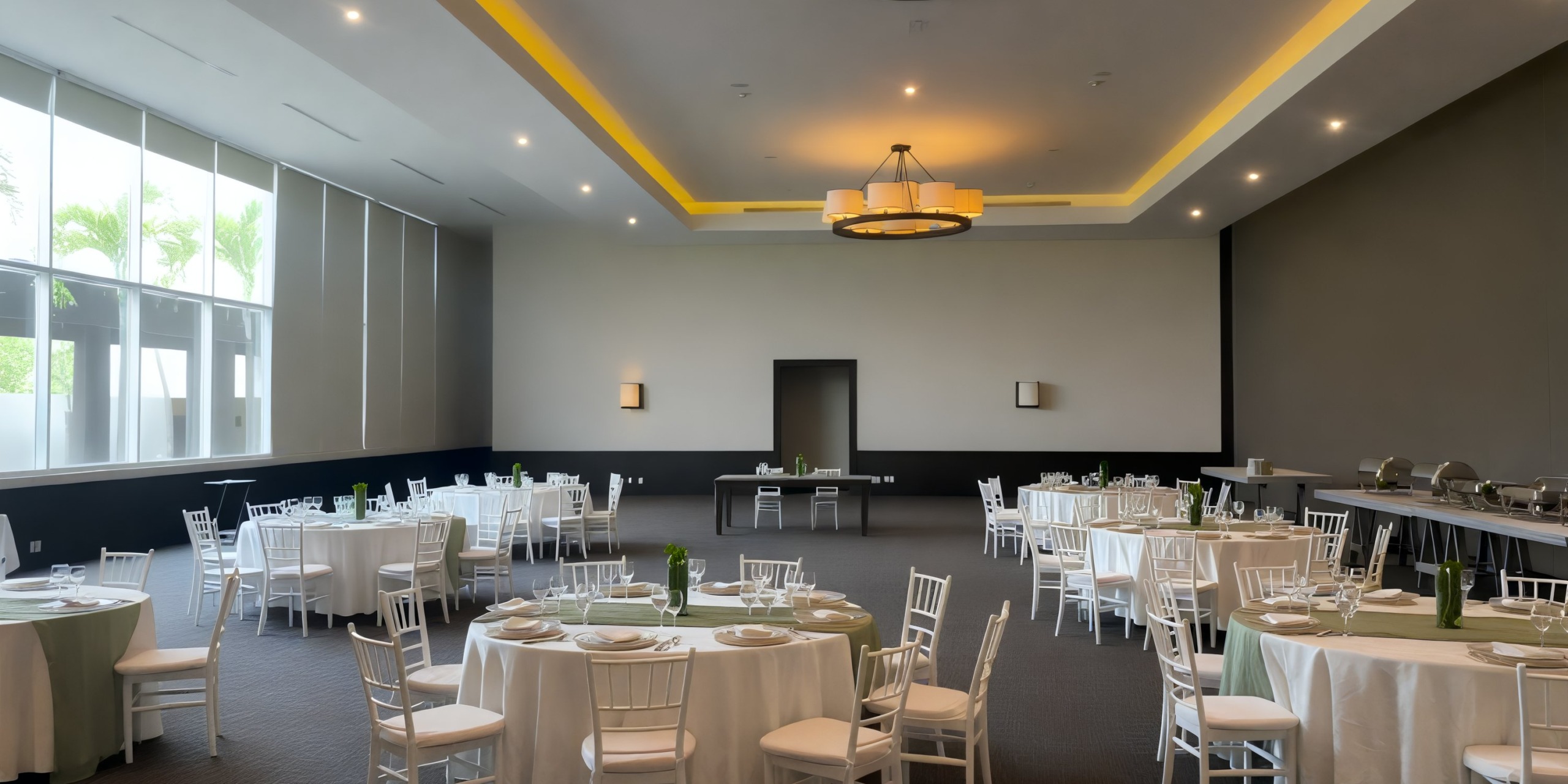 Vacant aspirations fill the Jade Hall, where round tables adorned with white chairs lie in wait for the approaching guests of the destination wedding.