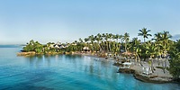 Hilton La Romana: a stunning tropical beachfront resort, featuring palm trees, clear blue waters, and white sand—perfect for a romantic destination wedding.