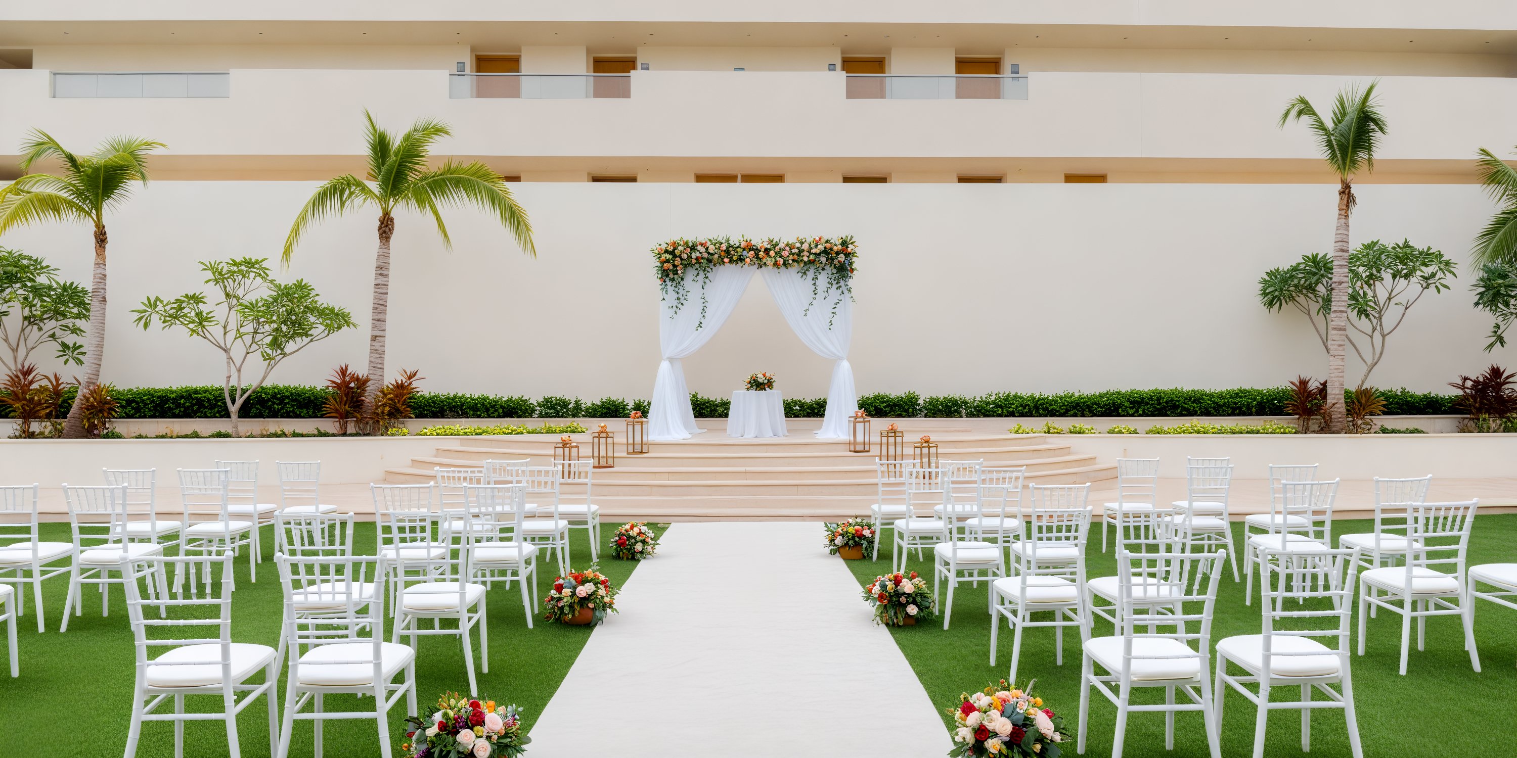 Dreams Natura destination wedding setup featuring elegant white chairs, beautiful floral arrangements, and a gorgeously decorated altar—perfect for an unforgettable outdoor ceremony.