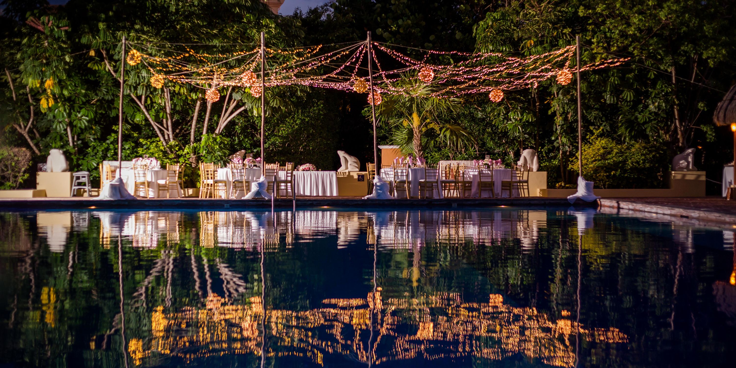 Dreams Sapphire's outdoor dining glows with string lights, perfect for a romantic destination wedding.