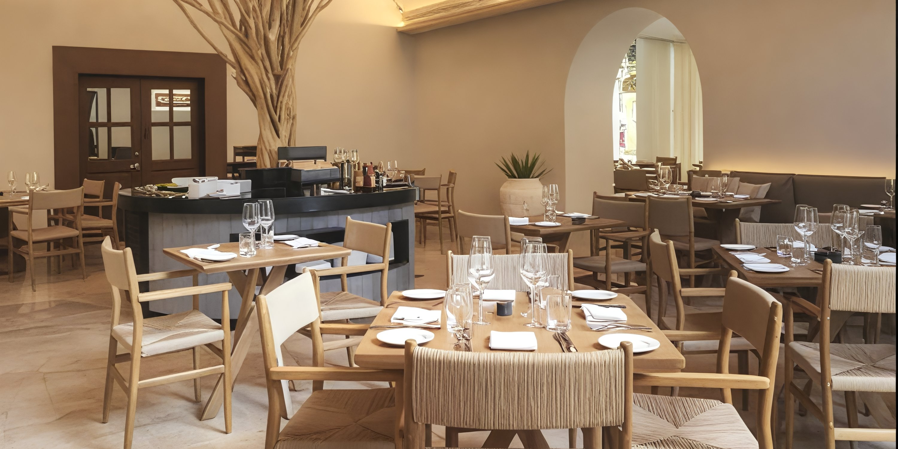 Grand Palladium Colonial: Modern dining area with wooden tables, ideal for a destination wedding, bar in back.