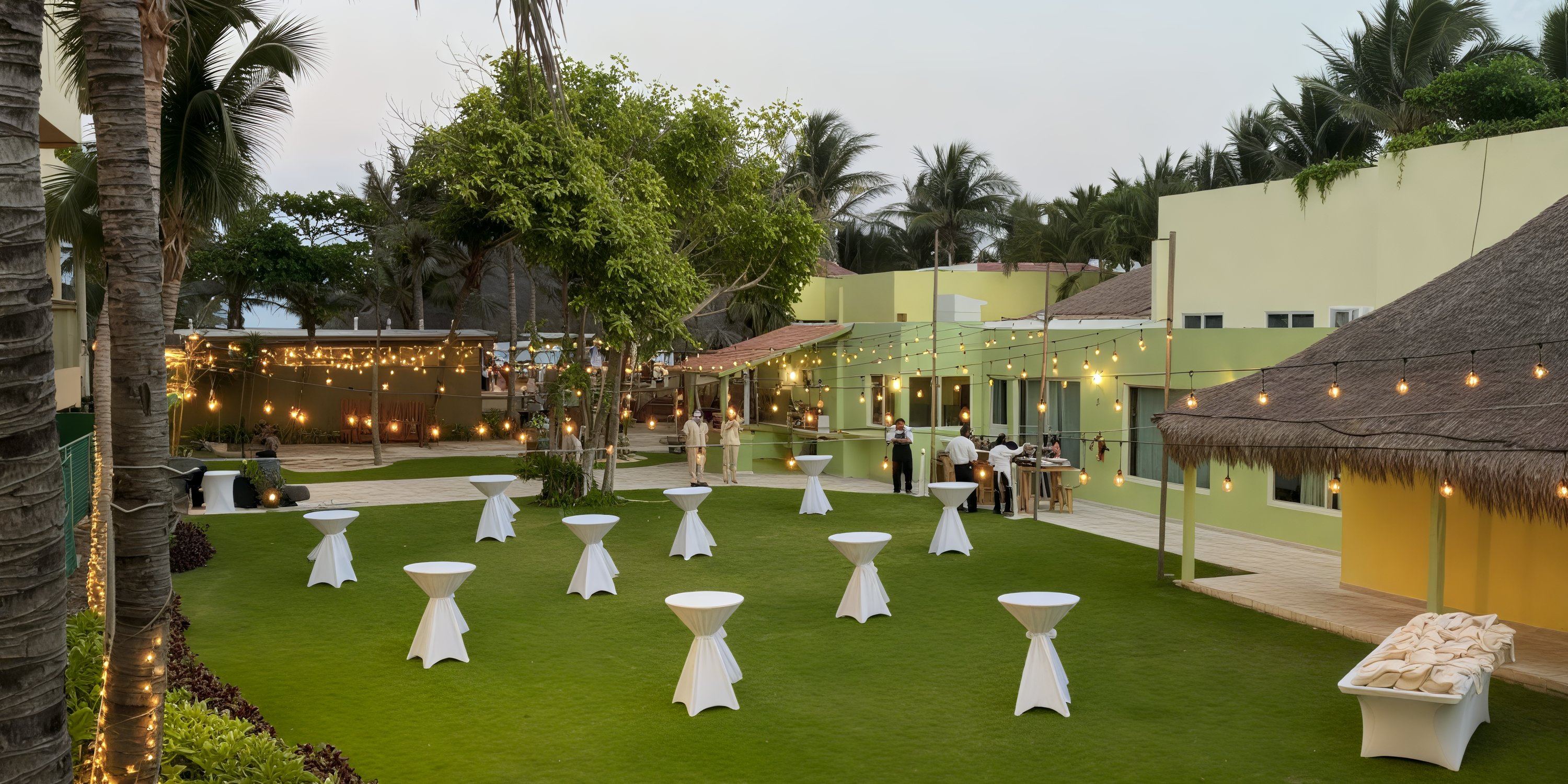 Generations Riviera Maya offers a picturesque setting for destination weddings, featuring round tables adorned with string lights and surrounded by palm trees in a beautiful outdoor daytime venue.