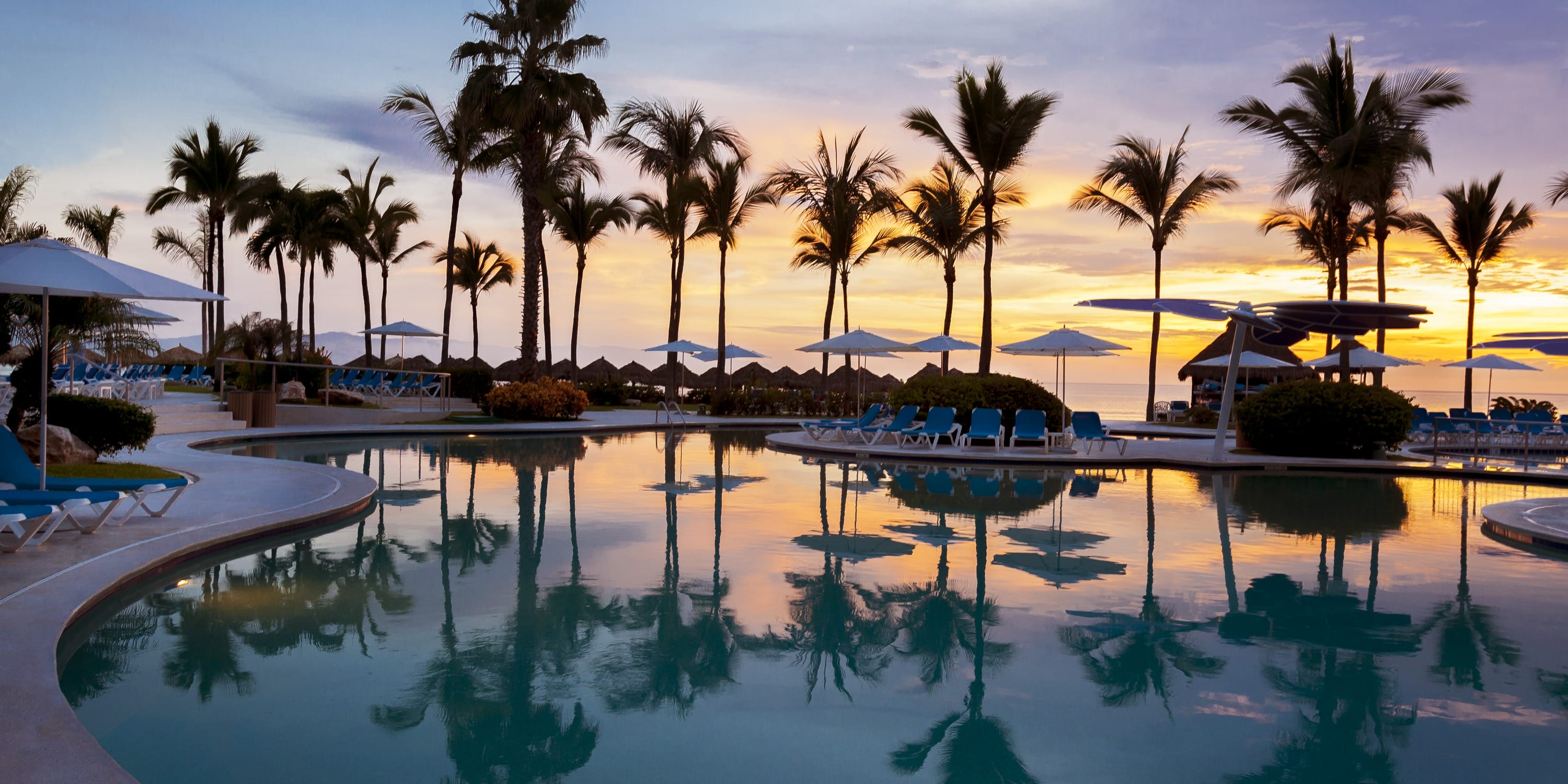 Sunset at the Hard Rock Vallarta resort pool, a perfect setting for a destination wedding.