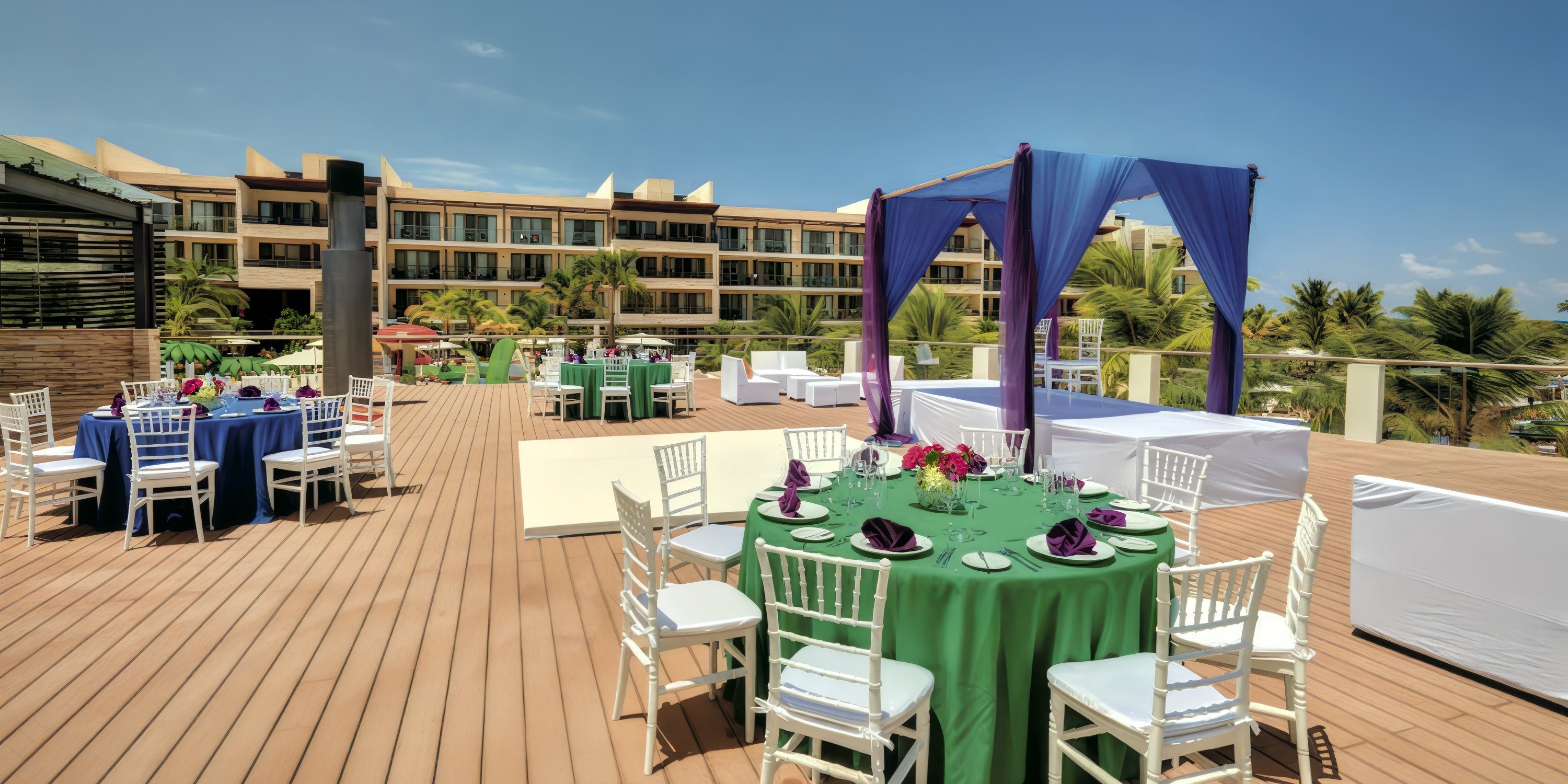 Destination wedding setup at Hideaway at Royalton Riviera Cancun with round tables, chairs, and canopy.
