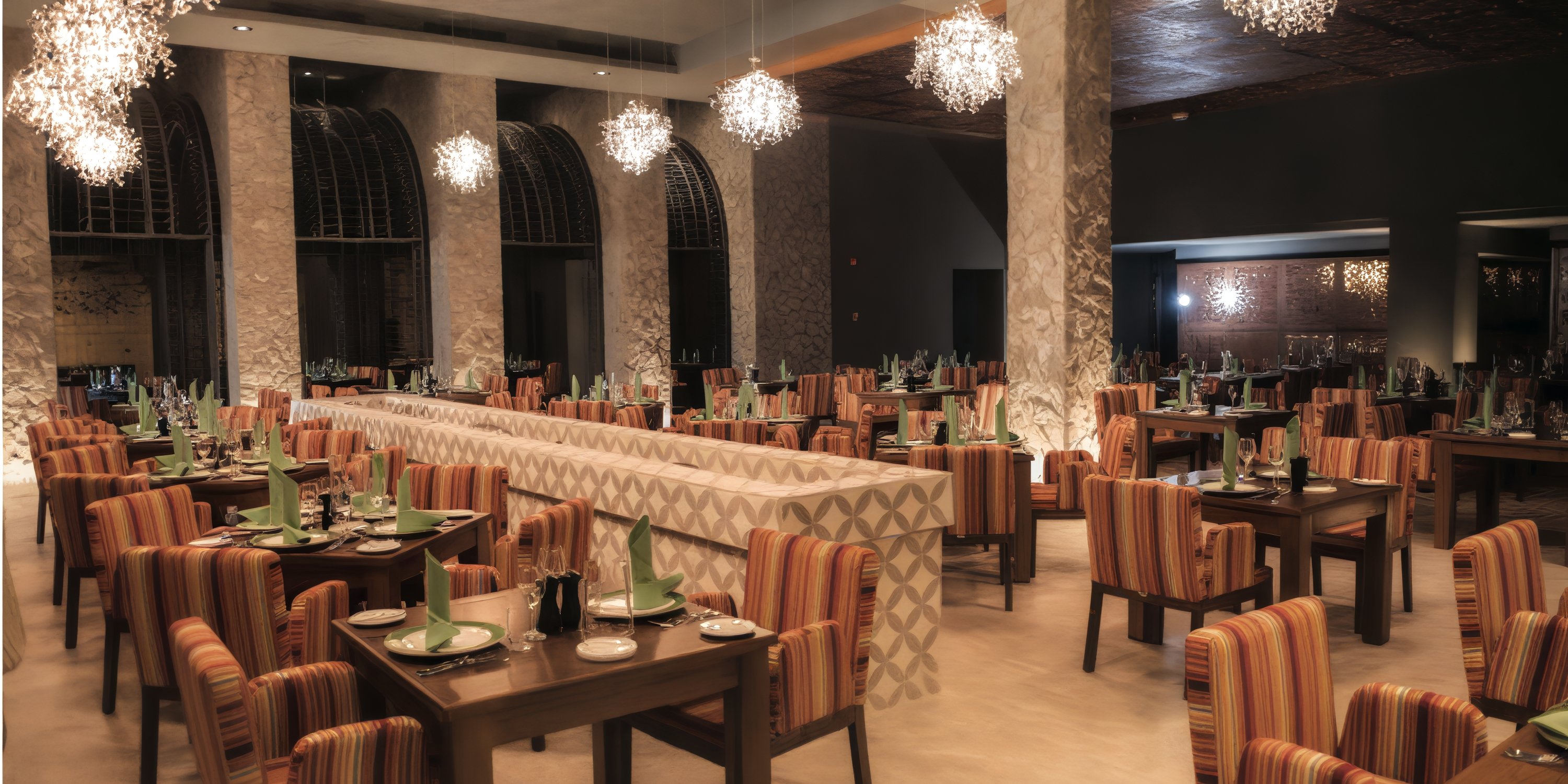 Elegant space at Royalton Riviera Cancun, perfect for a destination wedding, with striped chairs and set tables.