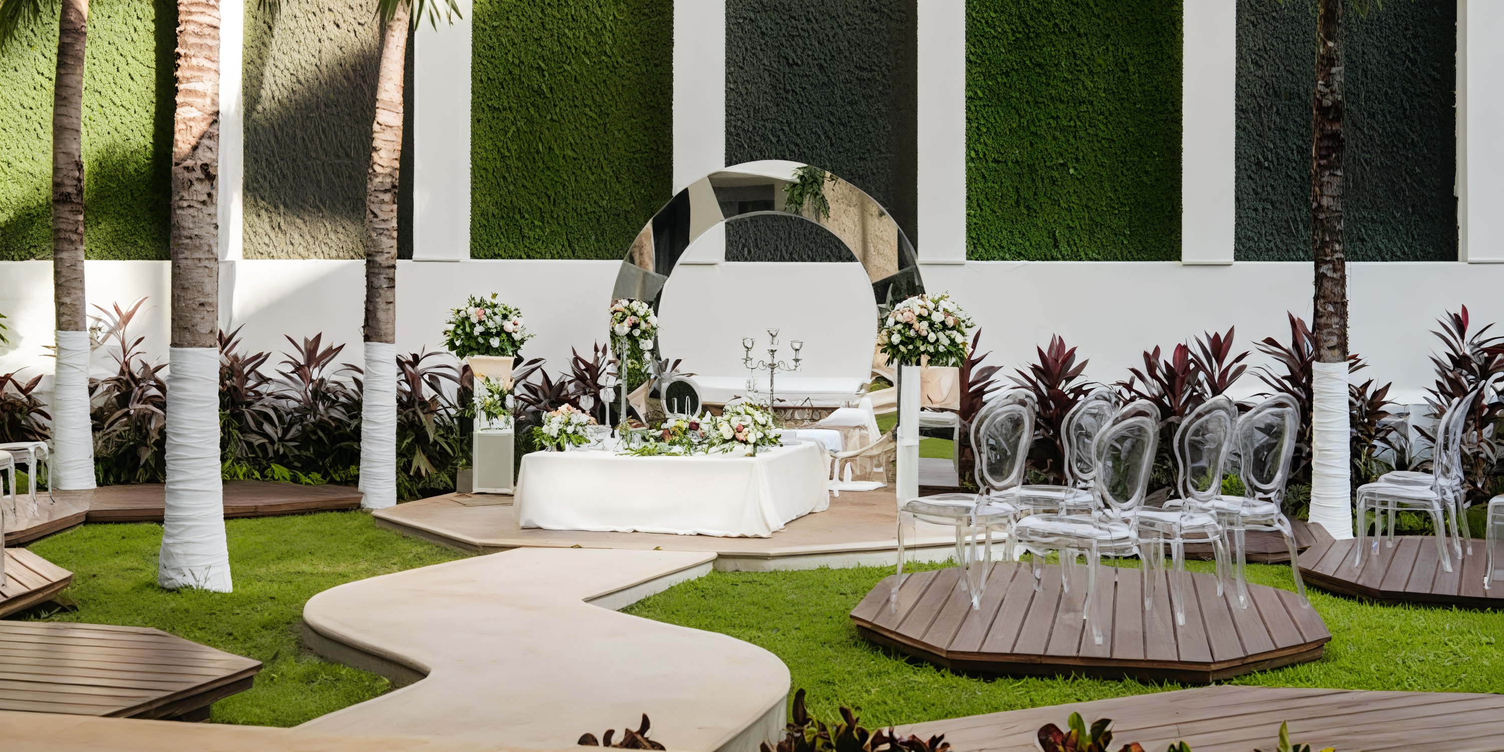 Chic destination wedding at Hyatt Vivid Playa del Carmen, featuring clear chairs and a floral arch.