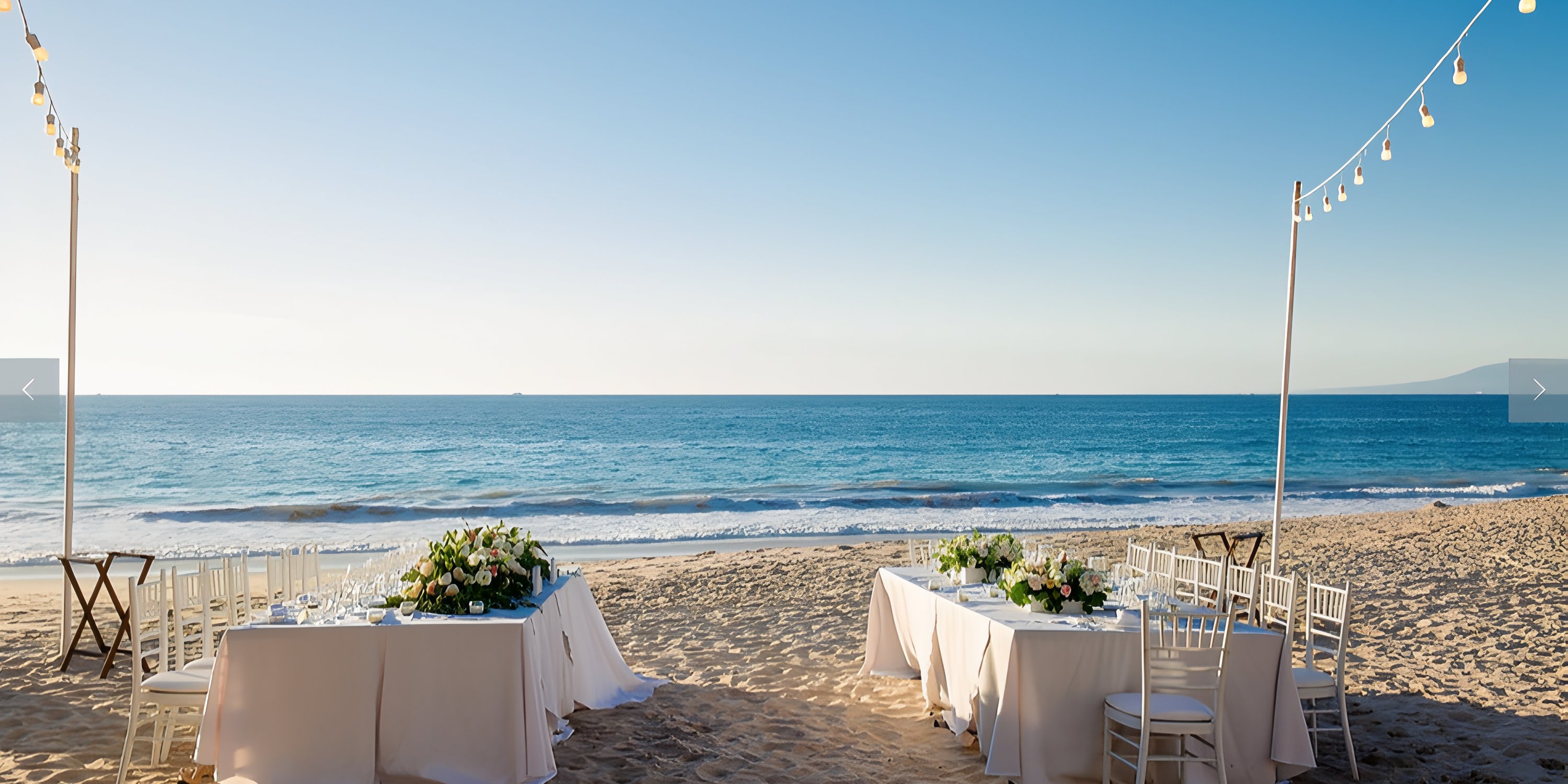 Tables and chairs decorated for a destination wedding on the sandy beach at Hyatt Ziva Puerto Vallarta.