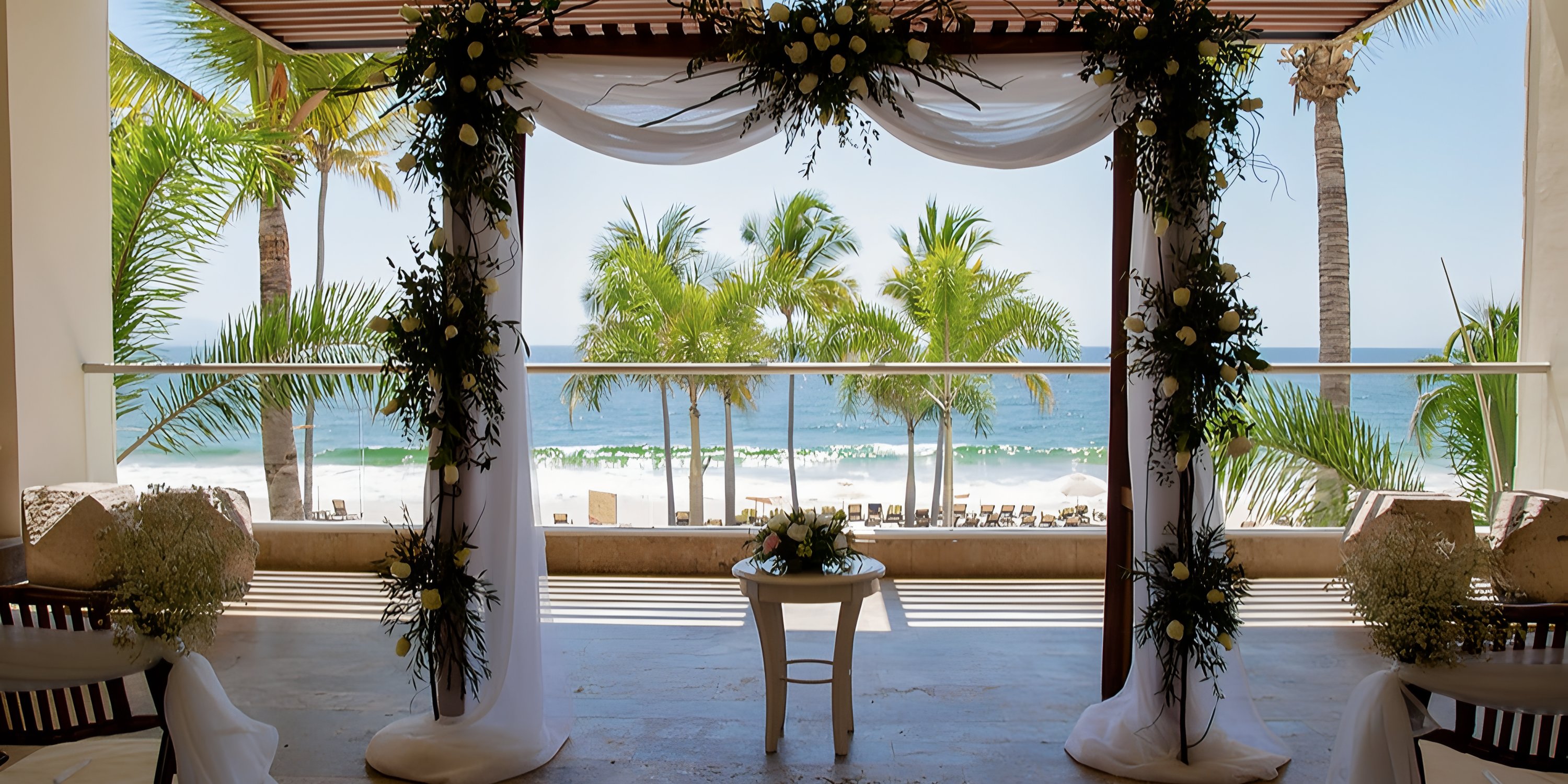 Wedding arch at Hyatt Ziva Puerto Vallarta, perfect for a destination wedding by the beach and palm trees.