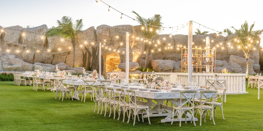 Plan a stunning destination wedding at Hyatt Ziva Cap Cana, featuring long tables and enchanting string lights for your outdoor celebration.