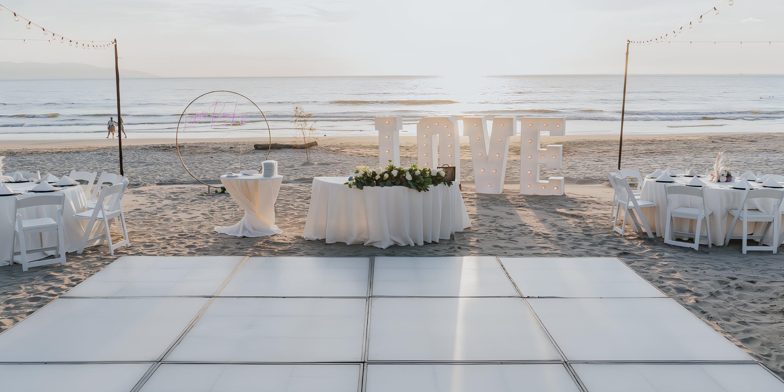 Destination wedding at Hard Rock Vallarta: beachside tables, dance floor, and giant "LOVE" letters at sunset.