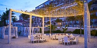 Beachside dining under string lights at dusk, perfect for a destination wedding at Hyatt Zilara Cancun.