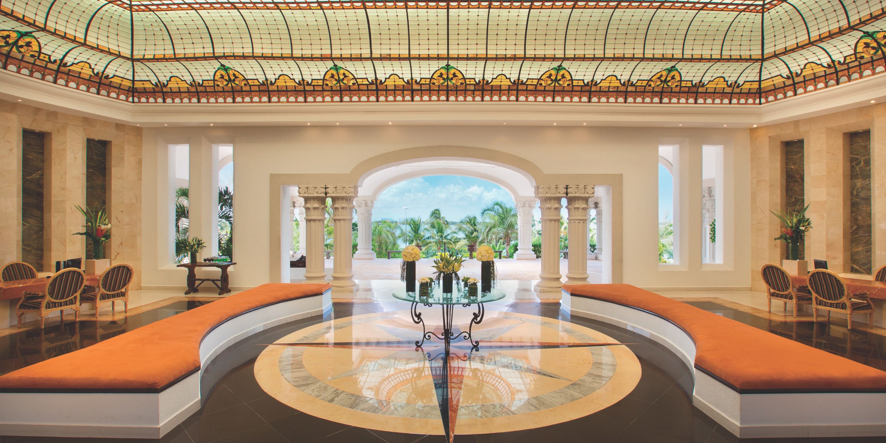 Hyatt Zilara Cancun&rsquo;s spacious lobby, ideal for a destination wedding, has a stained glass ceiling and orange benches.