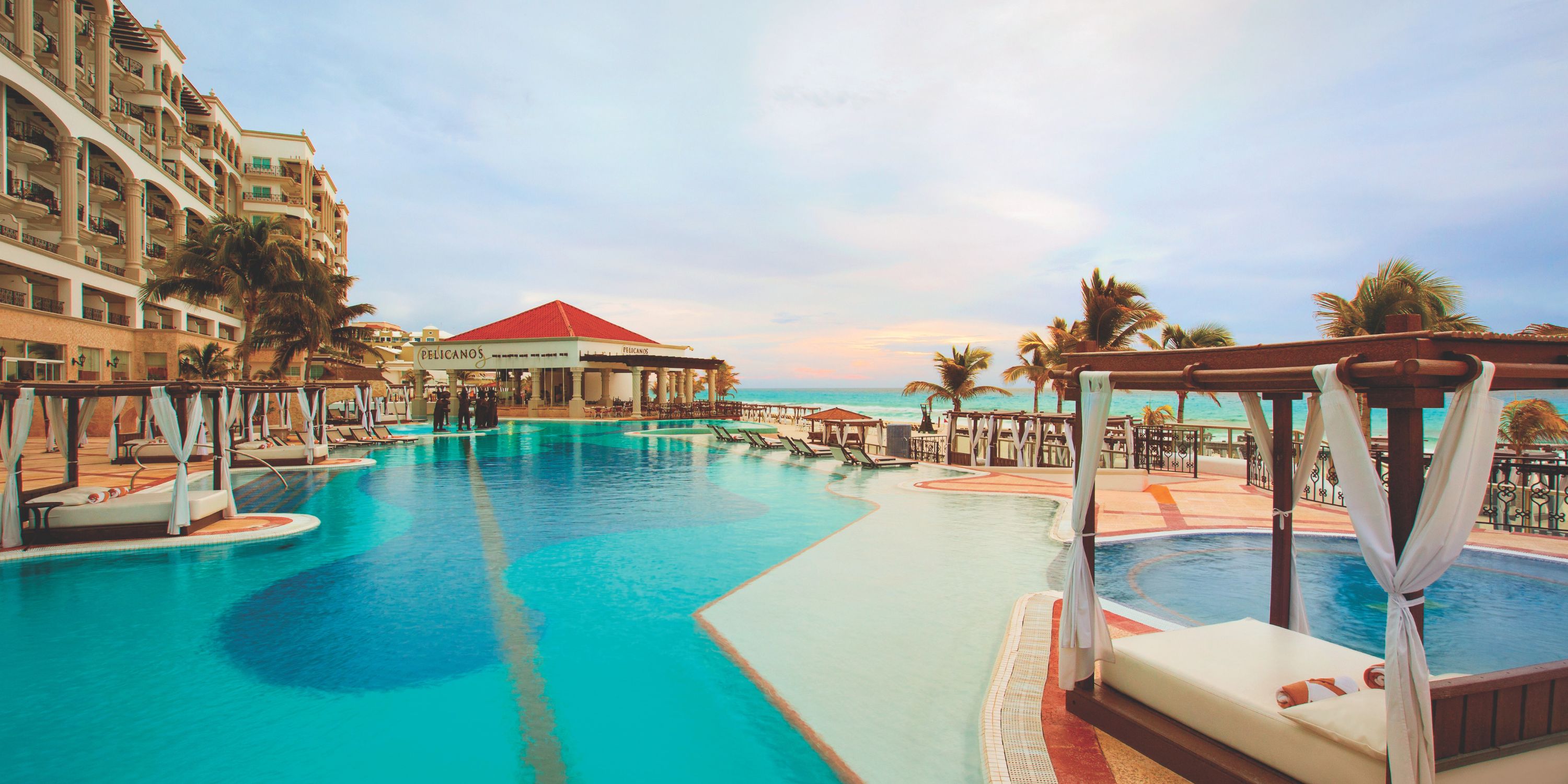 Hyatt Zilara Cancun&rsquo;s outdoor pool, ideal for a destination wedding, with canopied loungers and ocean view.