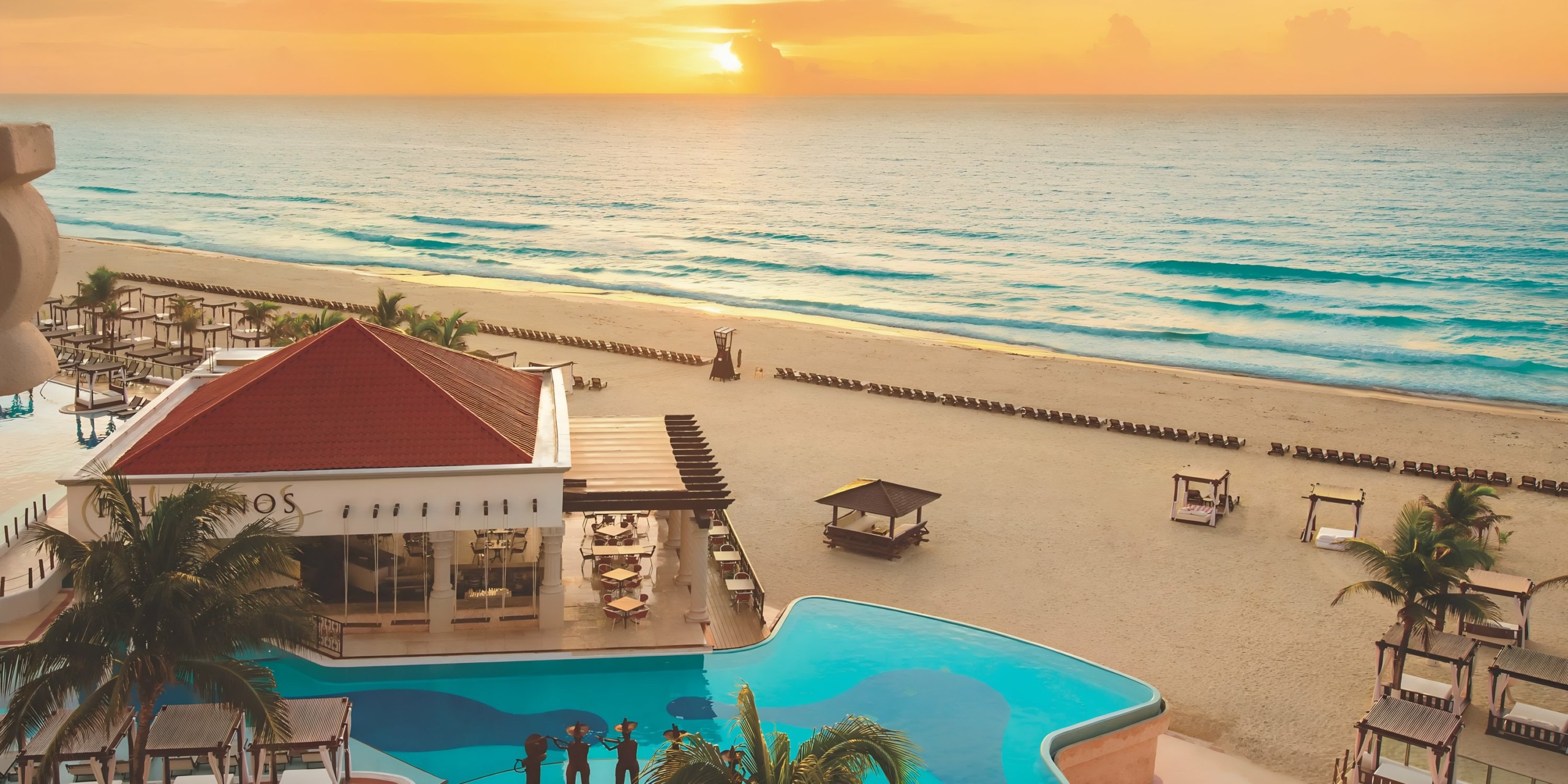Aerial view of Hyatt Zilara Cancun at sunset, featuring a swimming pool, beach cabanas, and the ocean horizon.