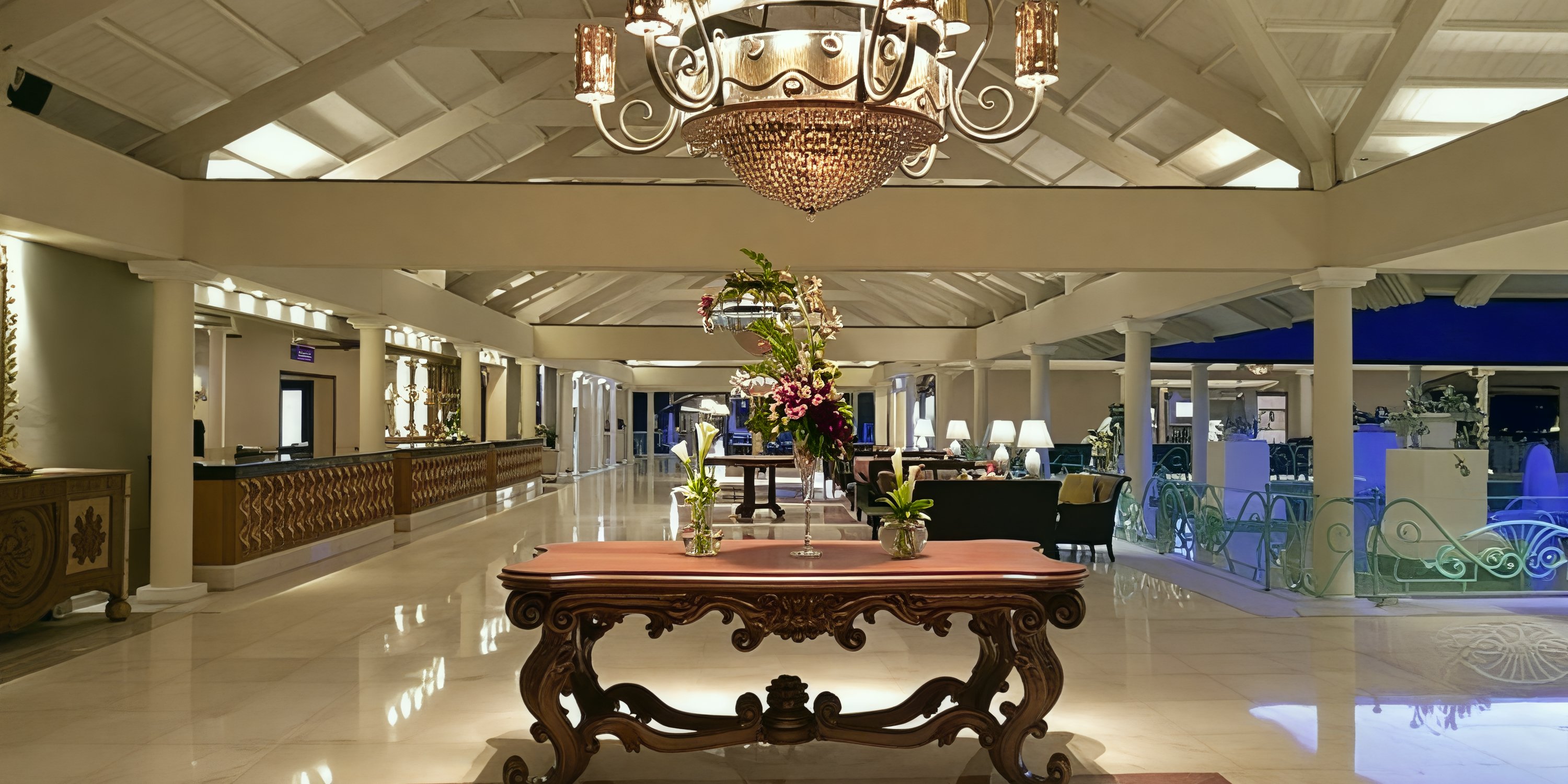 Sophisticated Iberostar Waves Punta Cana lobby, perfect for a destination wedding, with chandelier, flowers, and polished floors.