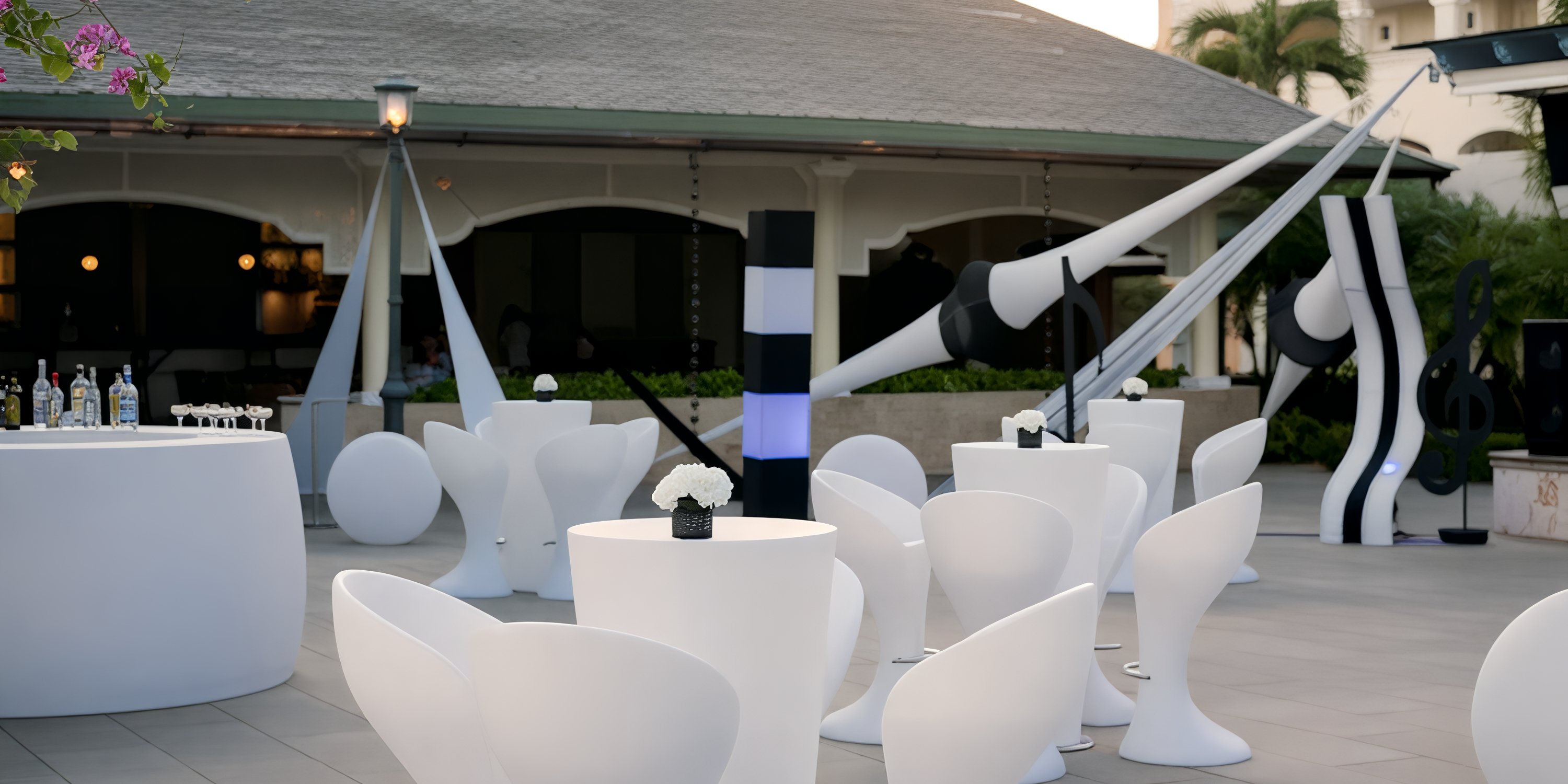 Outdoor patio at Iberostar Waves Punta Cana, ideal for a destination wedding, with white tables and bold decor.