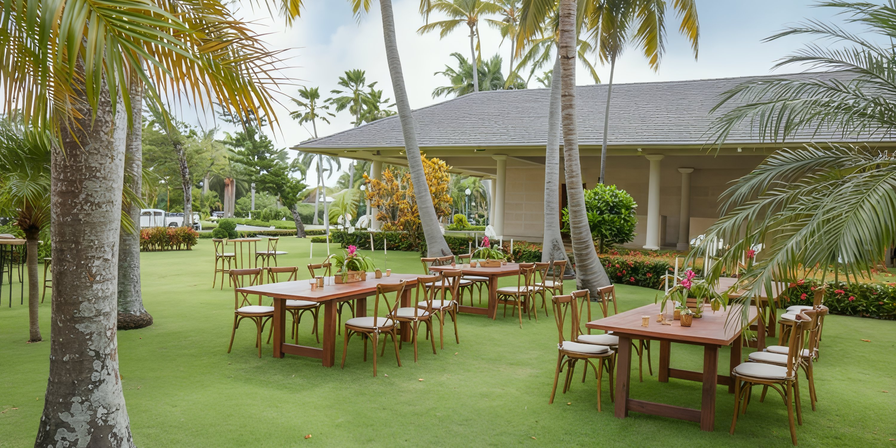 Outdoor dining area for destination weddings at Iberostar Waves Punta Cana, with palm trees and wooden tables.