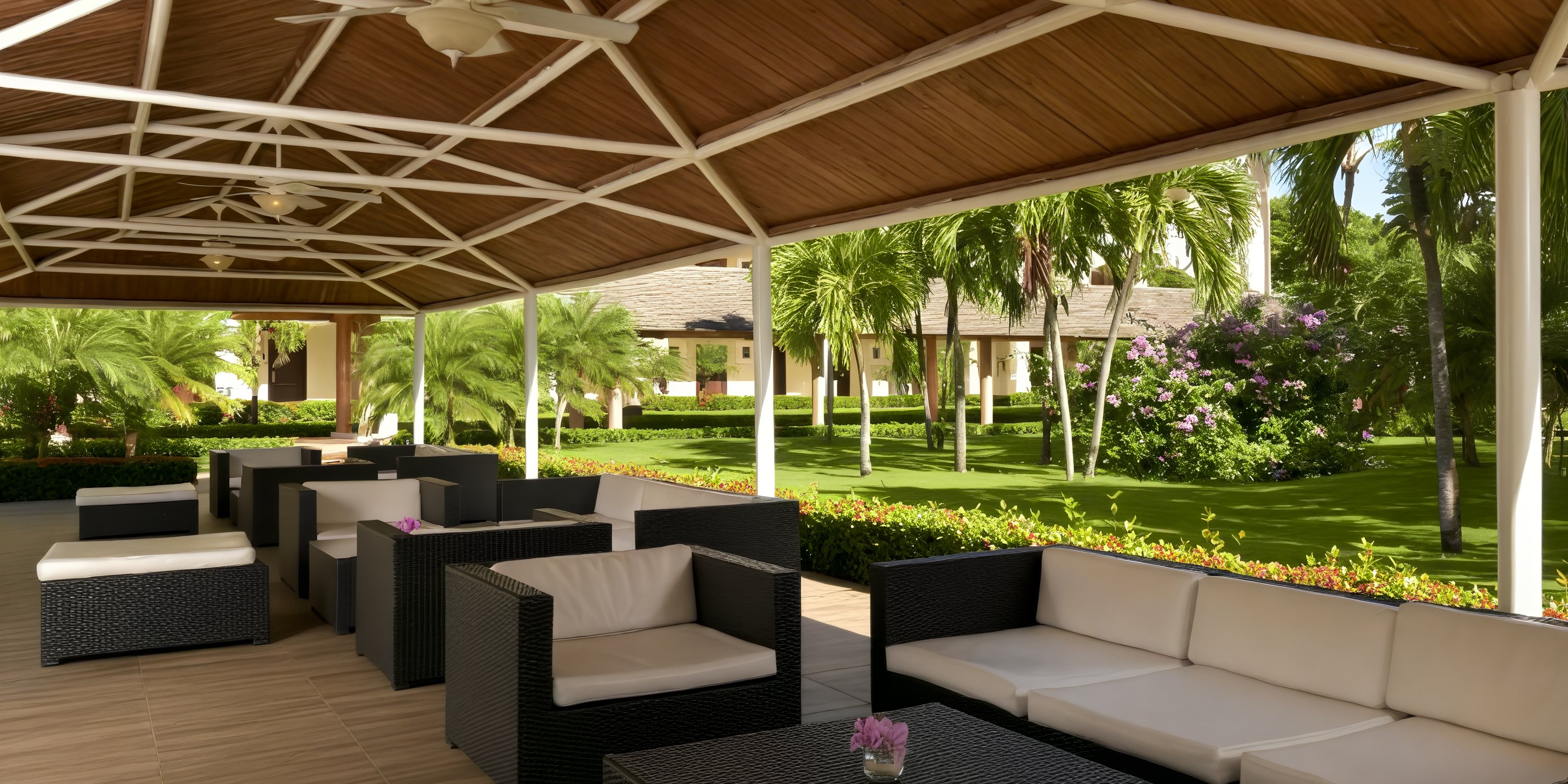 Outdoor seating with black wicker furniture at Iberostar Waves Punta Cana, ideal for a destination wedding.