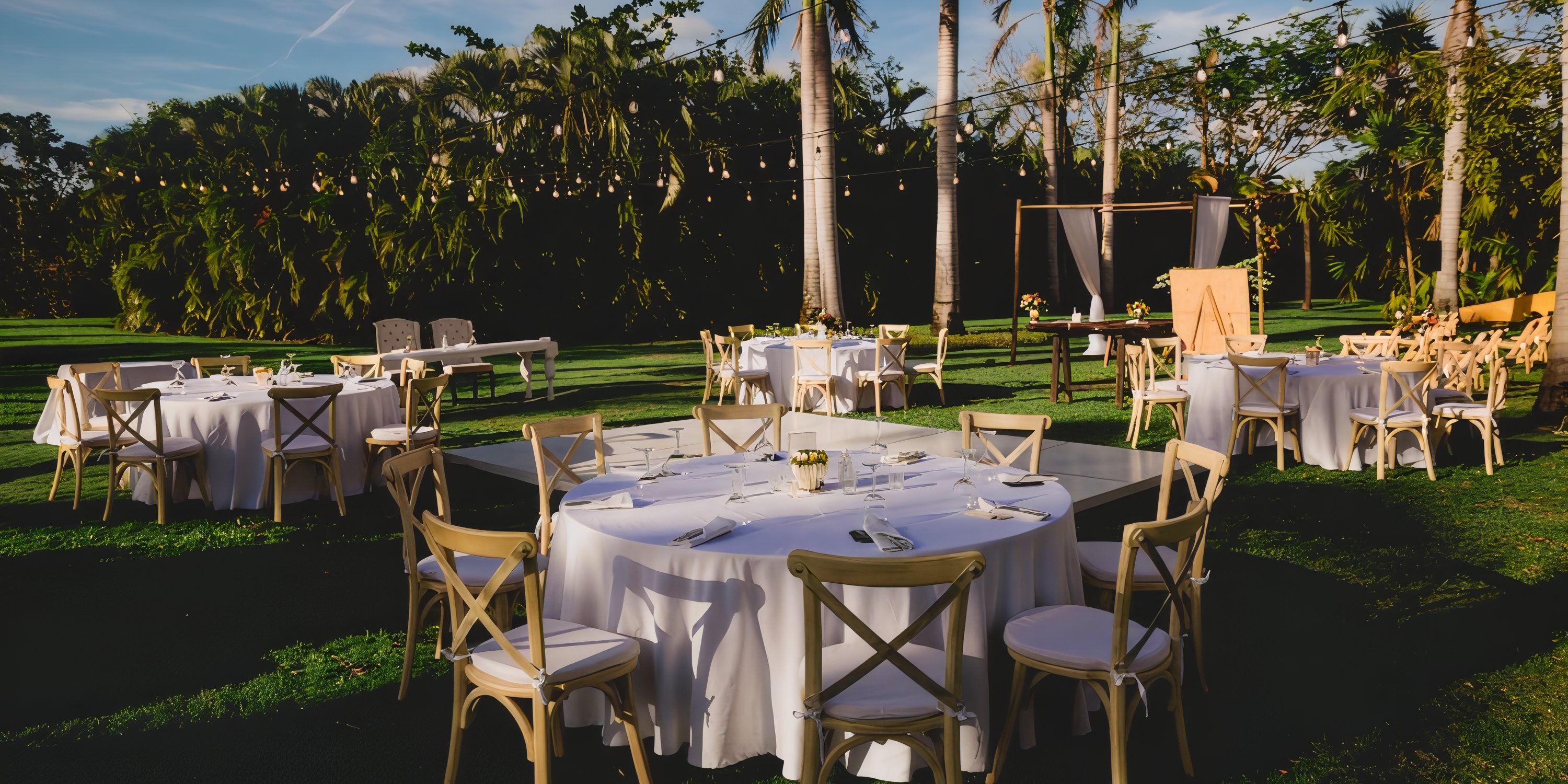 Destination wedding setup at Iberostar Selection Paraiso Lindo with round tables and string lights.