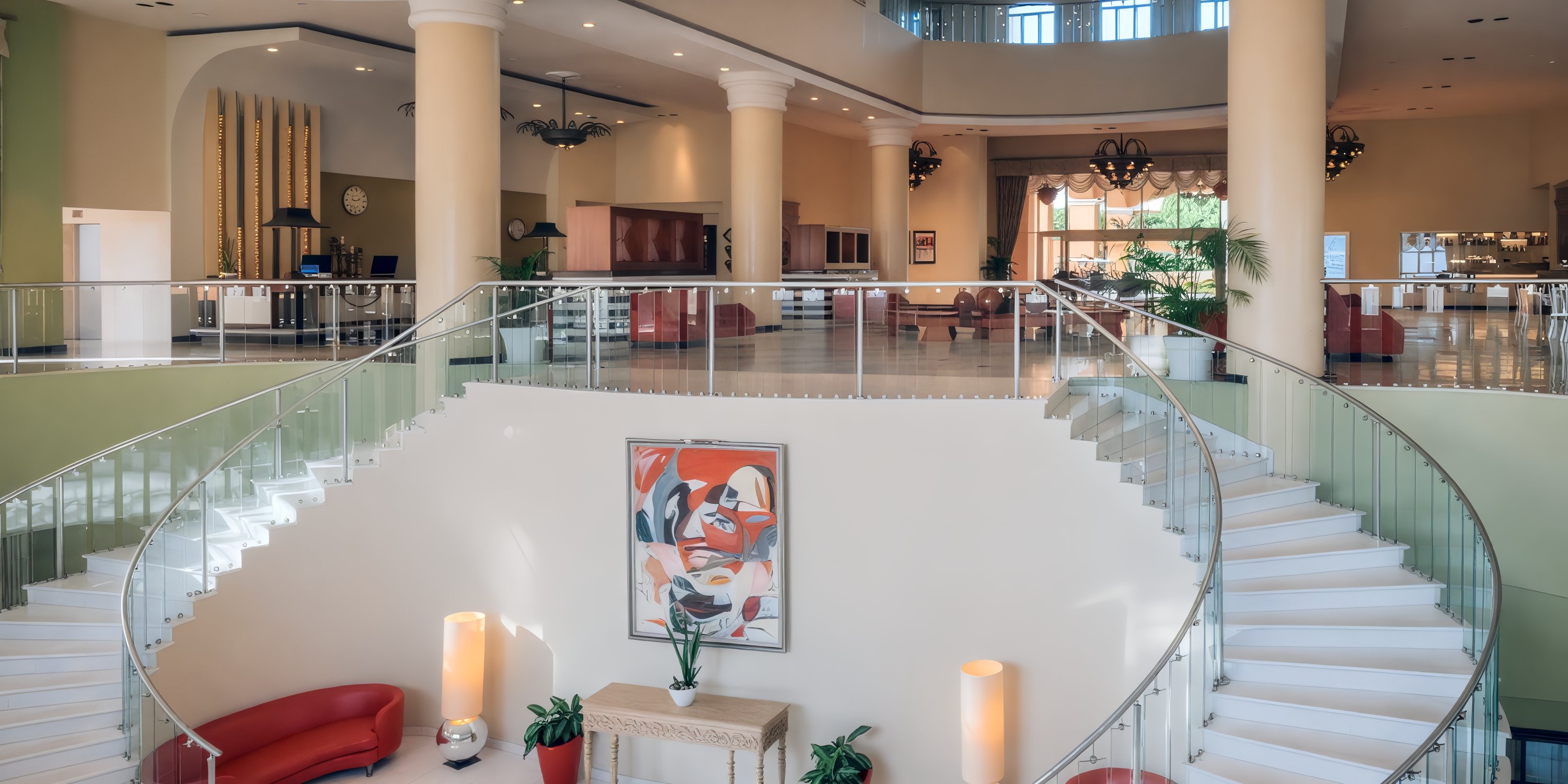Grand staircase in the elegant lobby of Iberostar Selection Rose Hall Suites, ideal for a destination wedding.