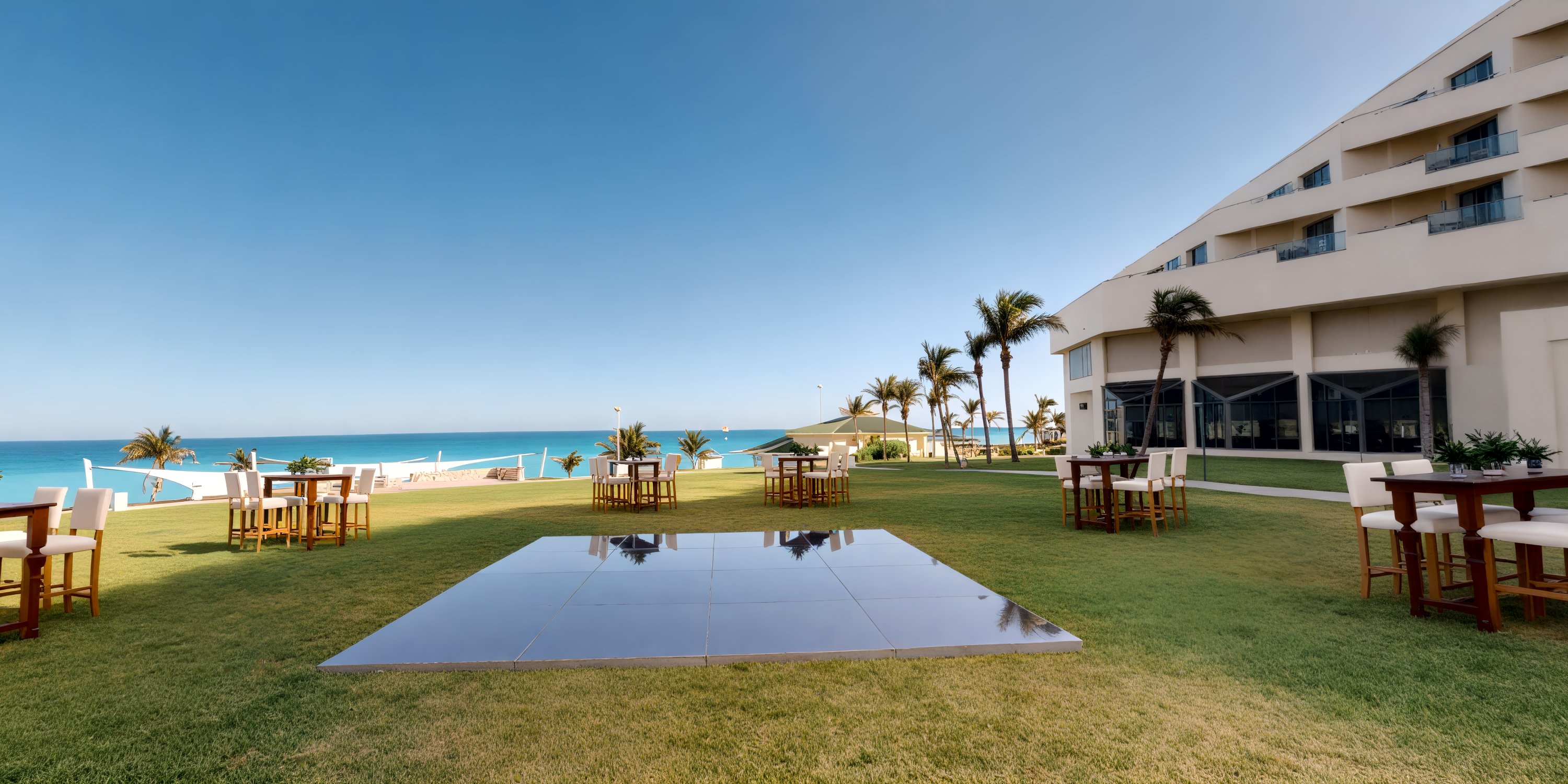 Scenic outdoor wedding venue at Iberostar Selection Cancun with seating, palm trees, and ocean views.