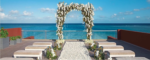 A Zoetry Paraiso de la Bonita wedding ceremony set up on a balcony overlooking the ocean.