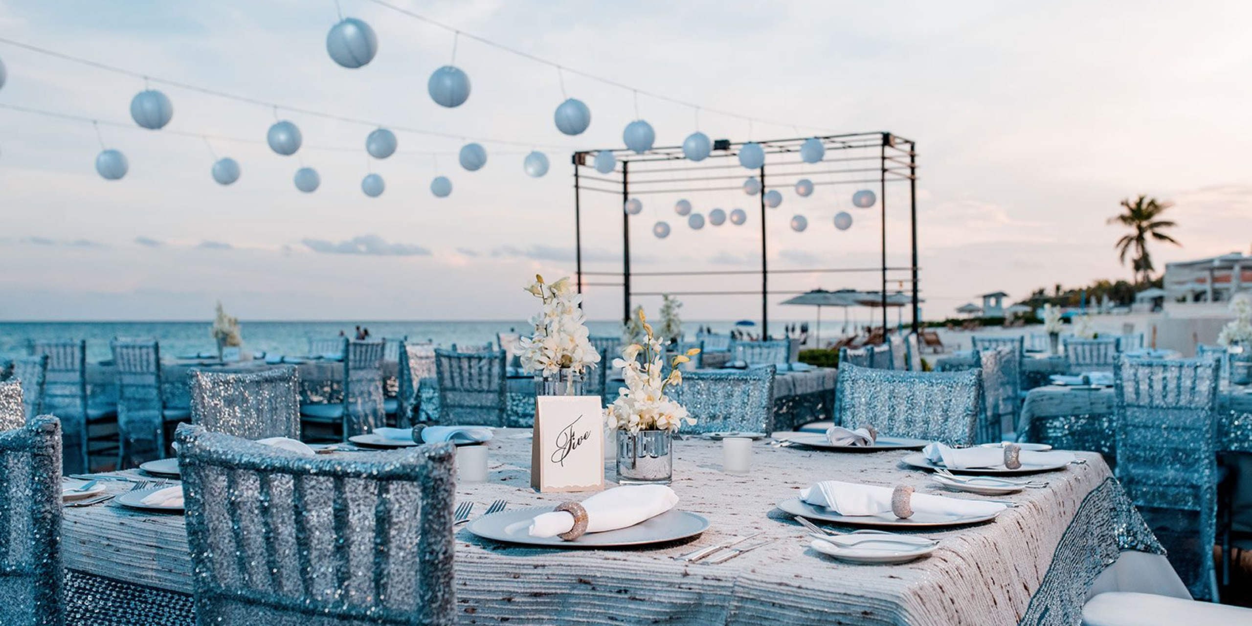 Outdoor beach venue sitting on white sand with a gazebo set up for a destination wedding