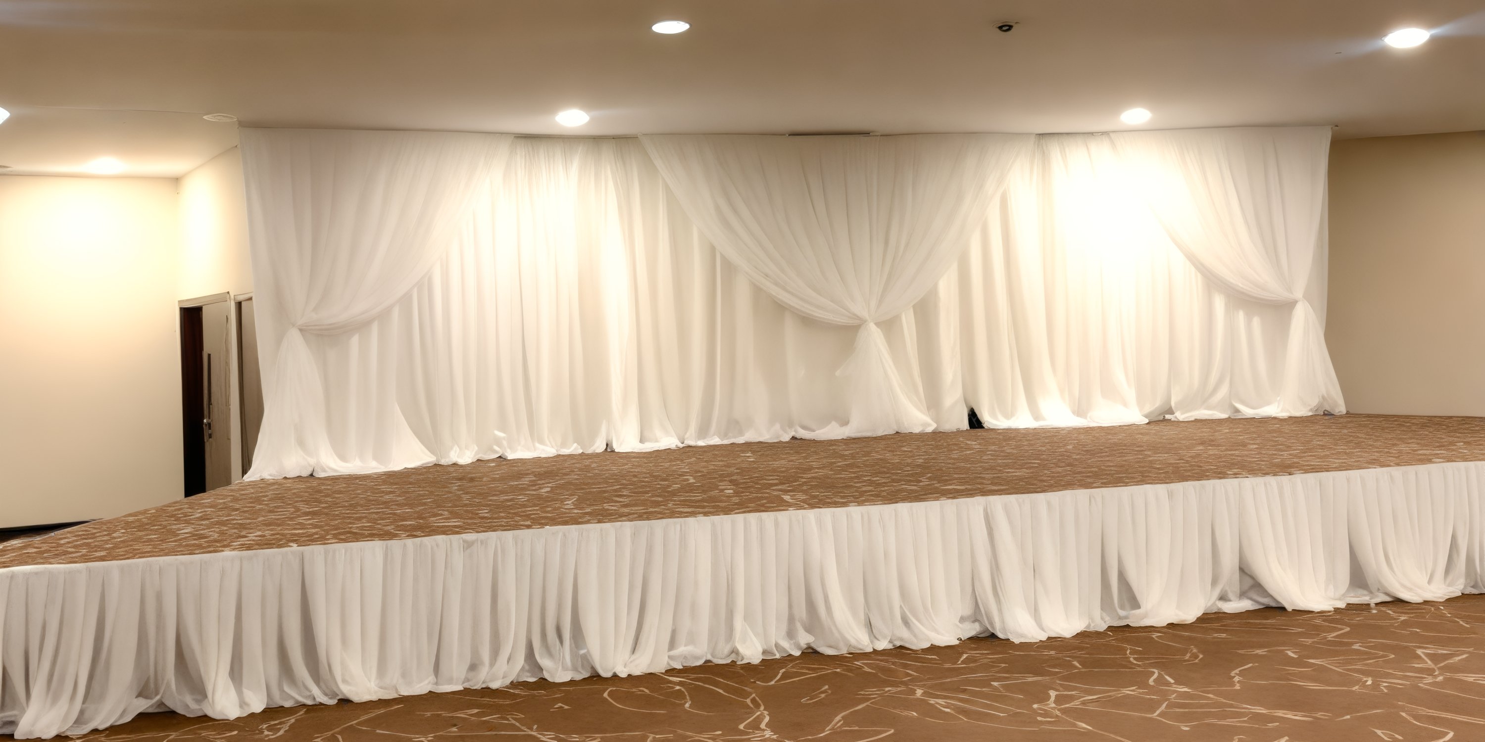 A stage with white drapes and brown carpet, set for a destination wedding at Hideaway at Royalton Blue Waters.
