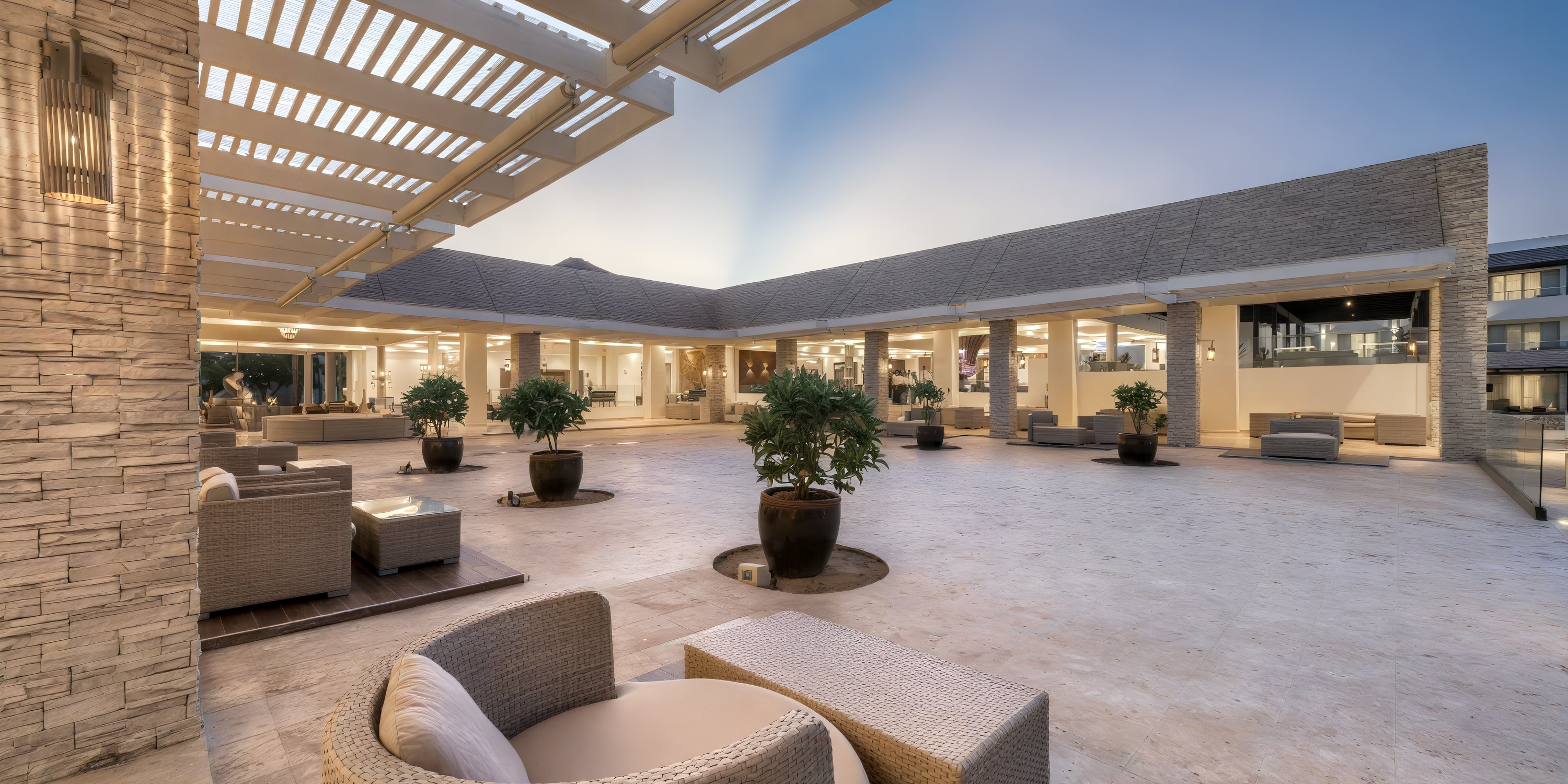 Royalton CHIC Punta Cana outdoor lounge with wicker seating, perfect for a destination wedding at dusk.