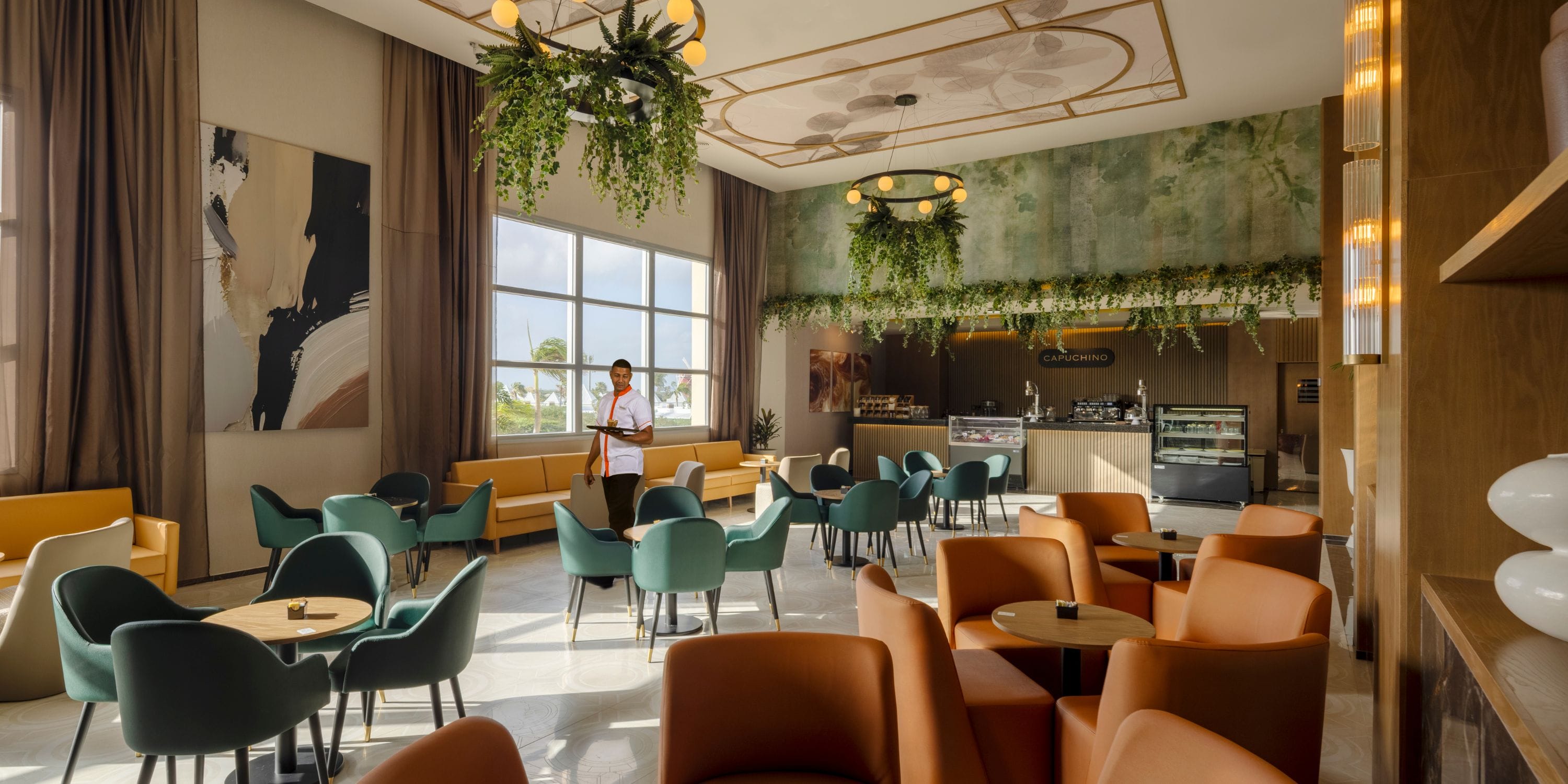 Hotel Riu Palace Aruba: Modern café, colorful seating—ideal for a destination wedding brunch.