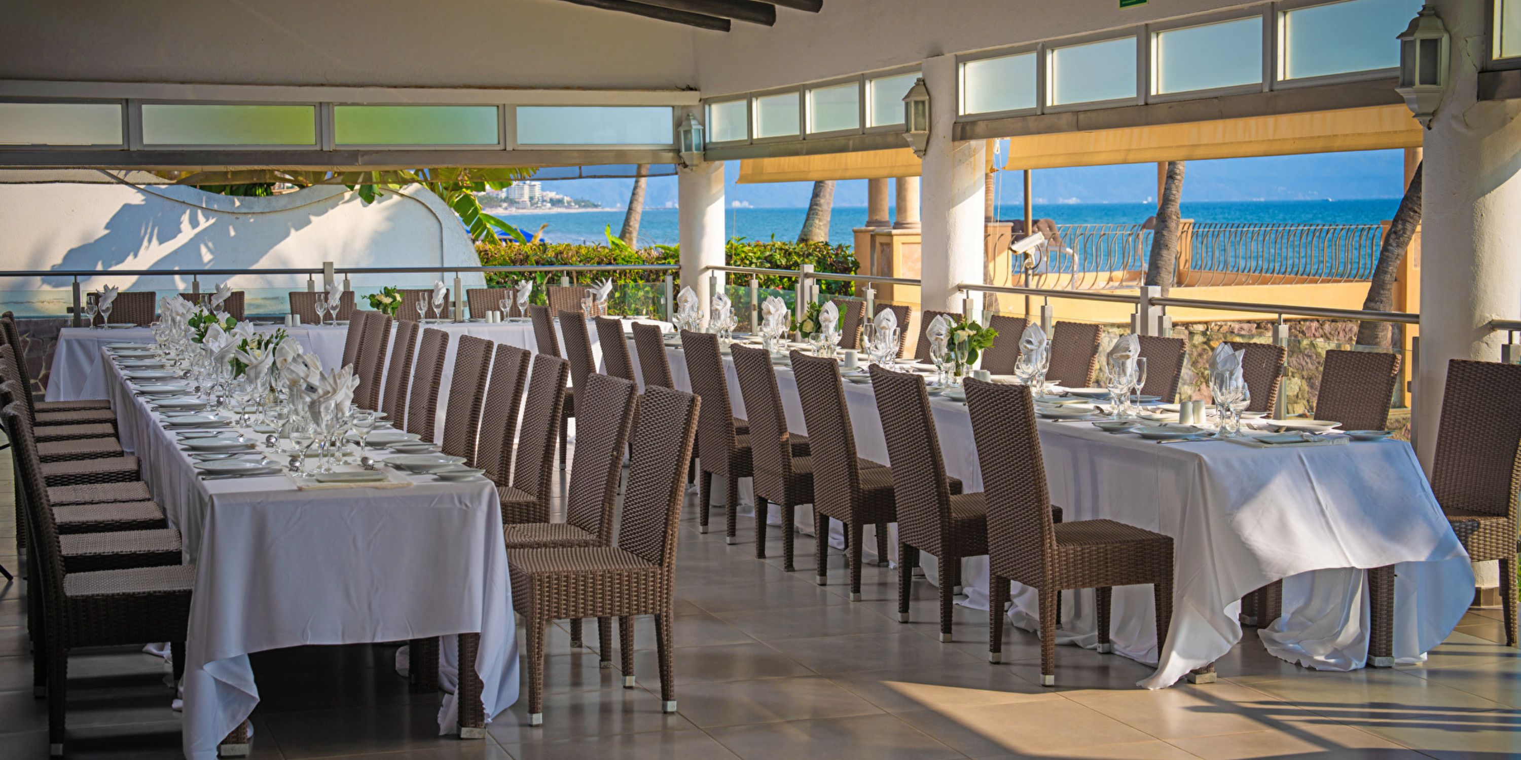 Two long tables arranged for a destination wedding at Hotel Riu Jalisco with an ocean view.