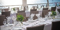 Elegant destination wedding dining at Hotel Riu Jalisco, white linens and florals by the waterfront.