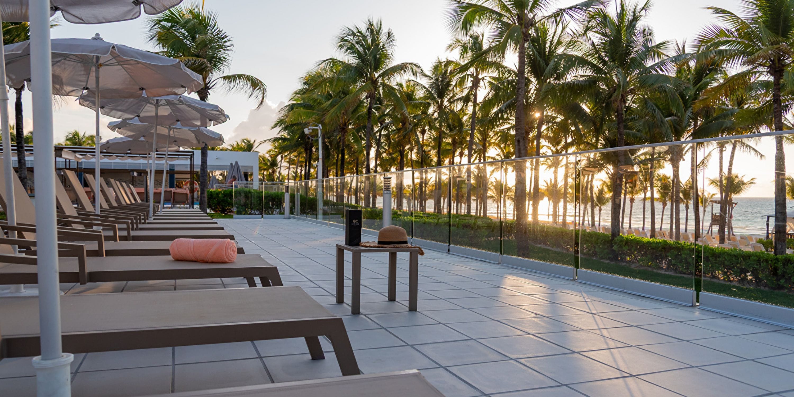 Lounge chairs by the pool at Hotel Riu Palace Riviera Maya, perfect for a sunset destination wedding.