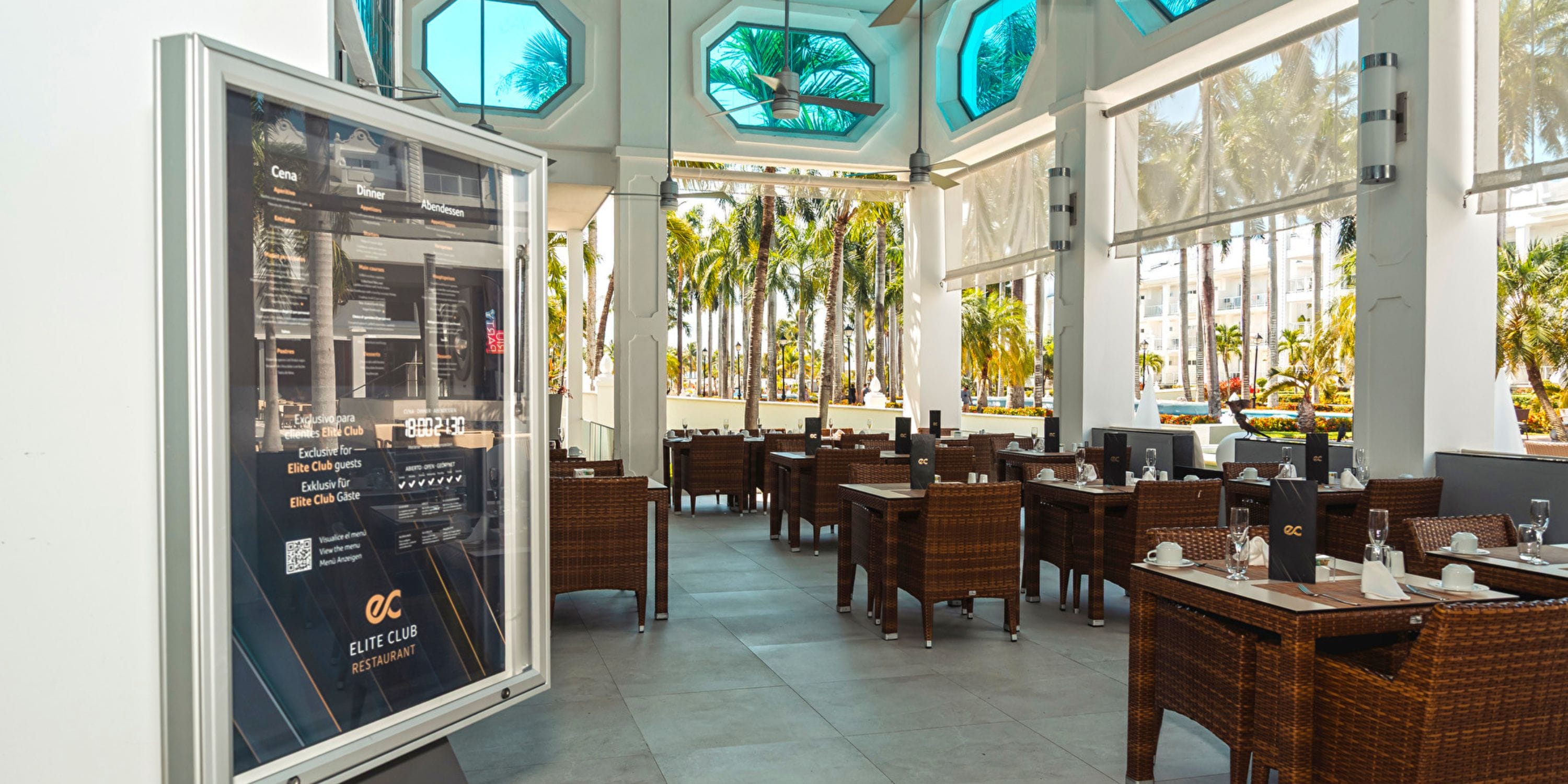 Hotel Riu Palace Riviera Maya offers outdoor dining with wicker seating, perfect for a destination wedding.