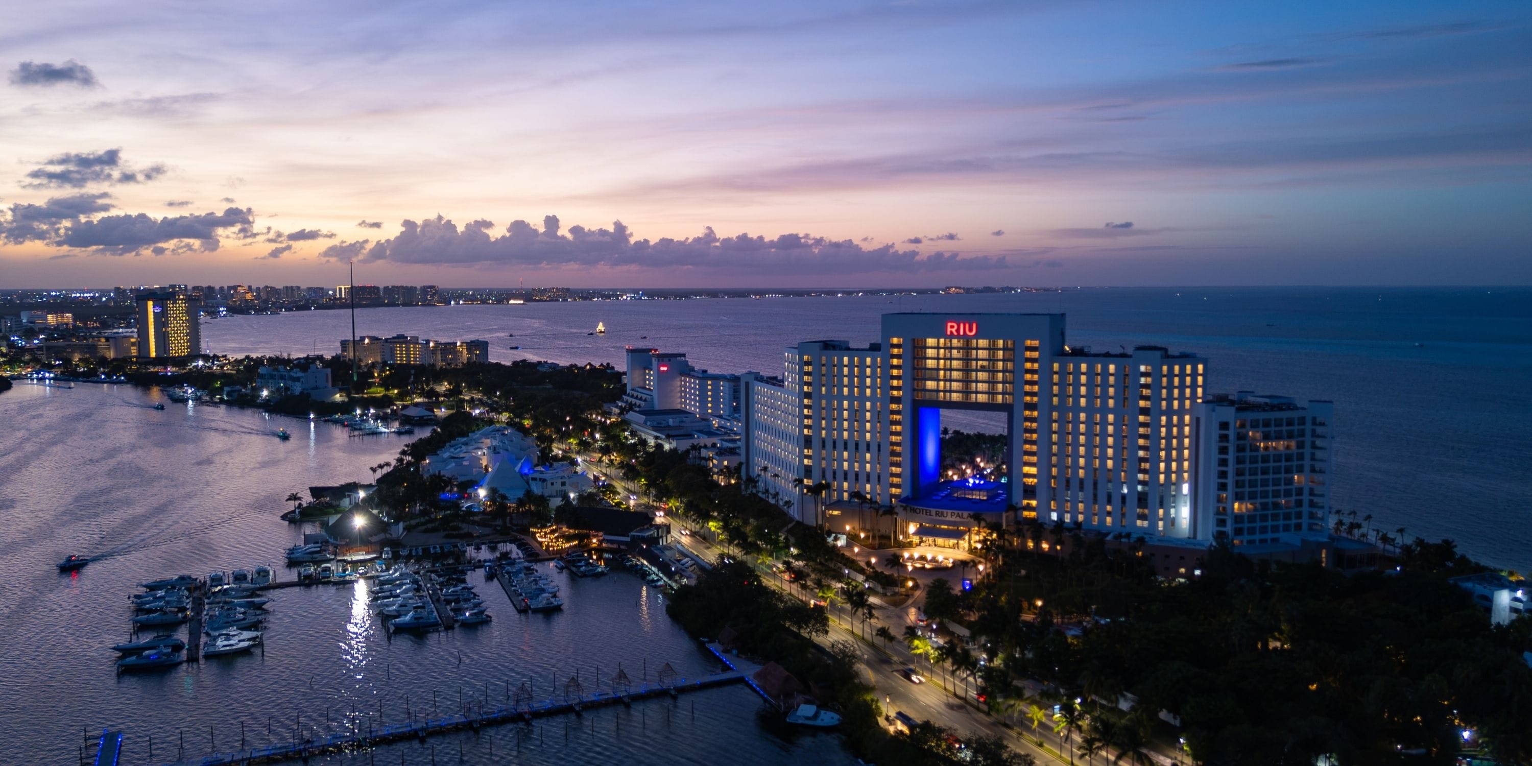 Aerial view of Hotel Riu Palace Peninsula at sunset, perfect for a romantic destination wedding.