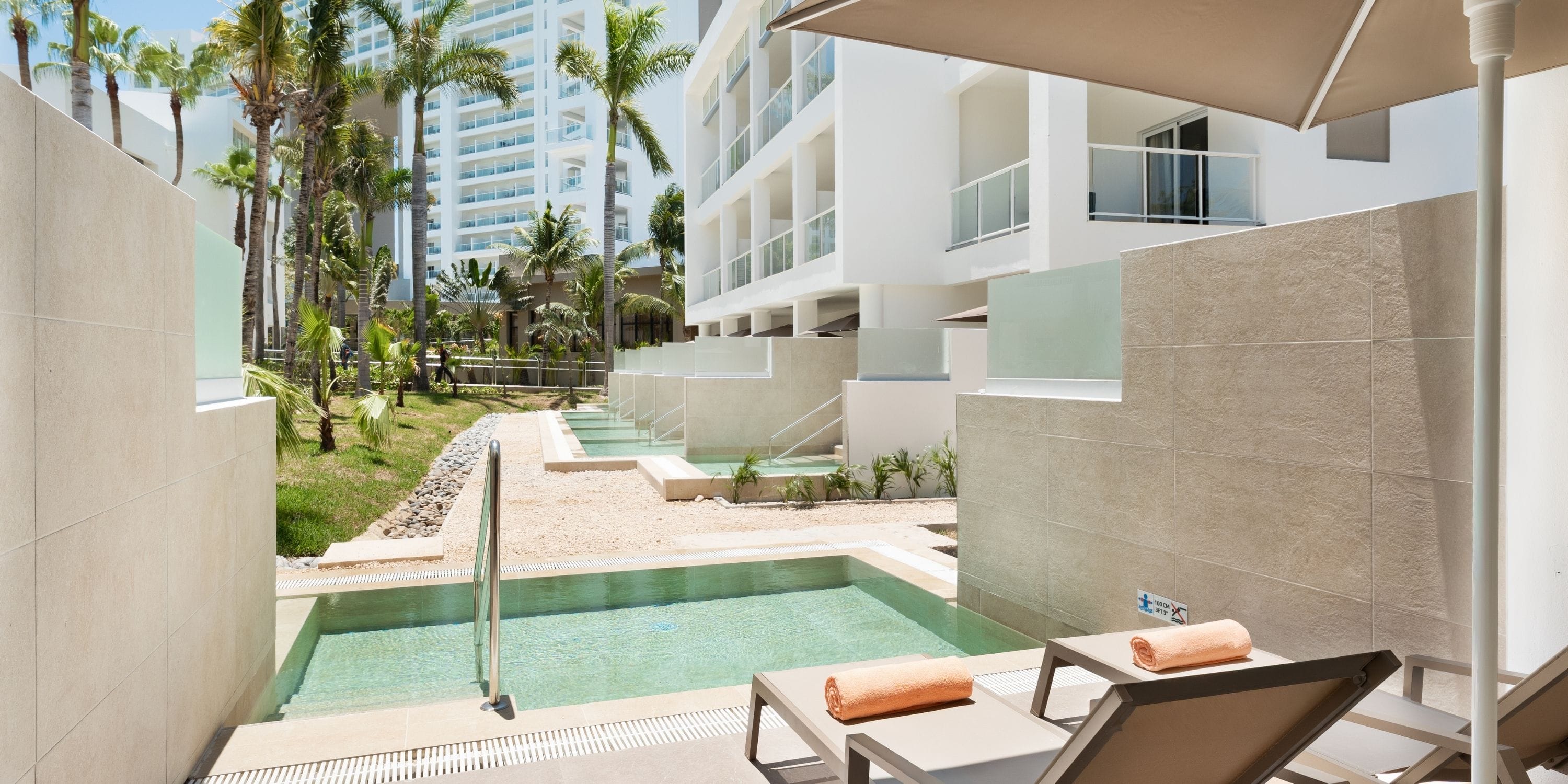 Lounge chairs and private pool at Hotel Riu Palace Peninsula, a dreamy destination wedding spot.