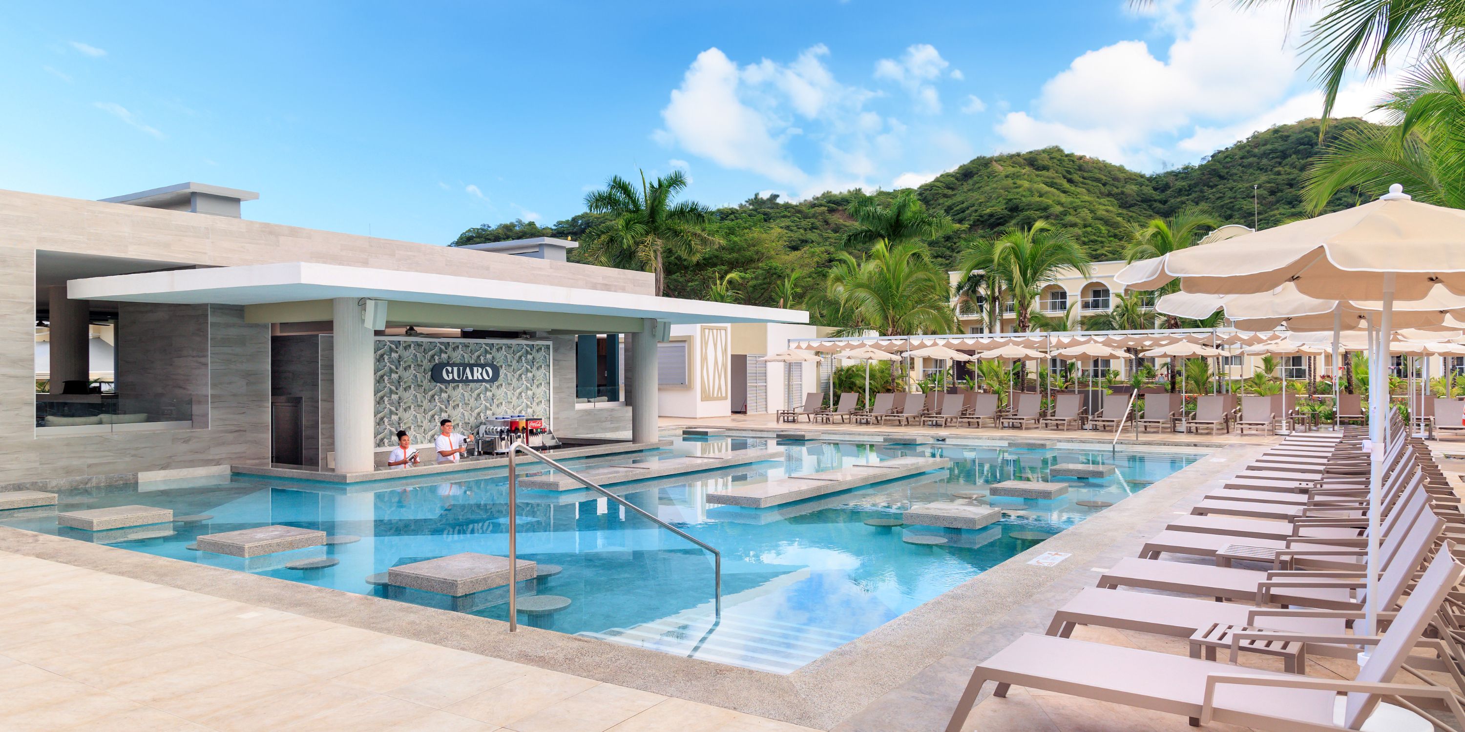 Hotel Riu Guanacaste is an ideal destination wedding venue, featuring an outdoor pool complete with a swim-up bar, comfortable loungers, and umbrellas for your guests to enjoy.
