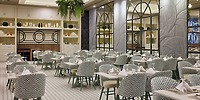 Elegant dining area at Hotel Riu Guanacaste, ideal for a destination wedding, with set tables and chic chairs.