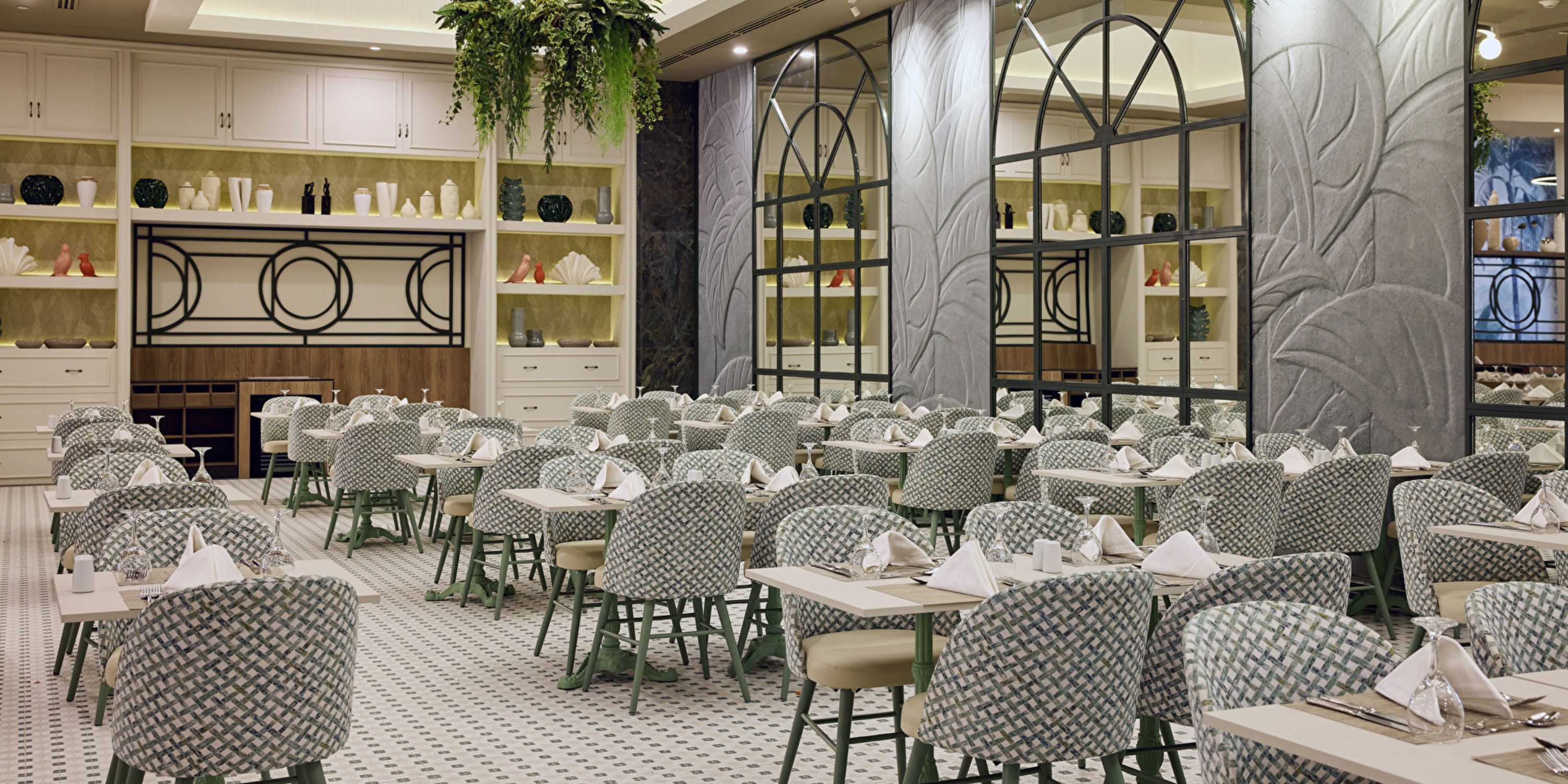 Elegant dining area at Hotel Riu Guanacaste, ideal for a destination wedding, with set tables and chic chairs.