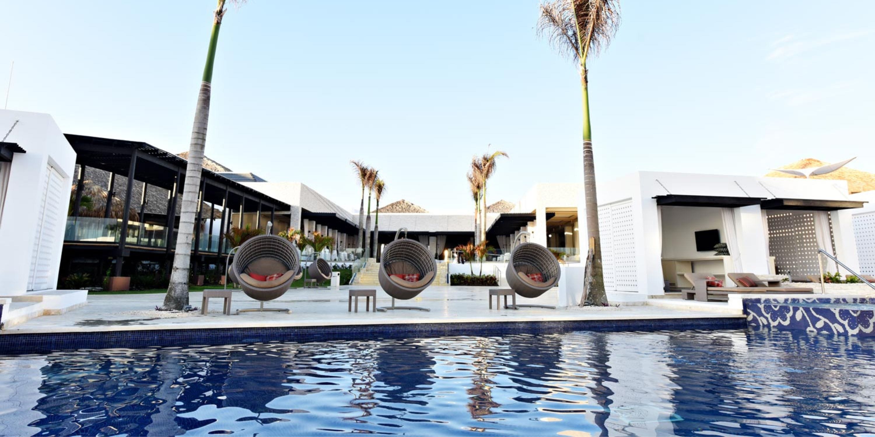 Modern poolside at Royalton CHIC Punta Cana&mdash;ideal for a destination wedding with chic loungers.
