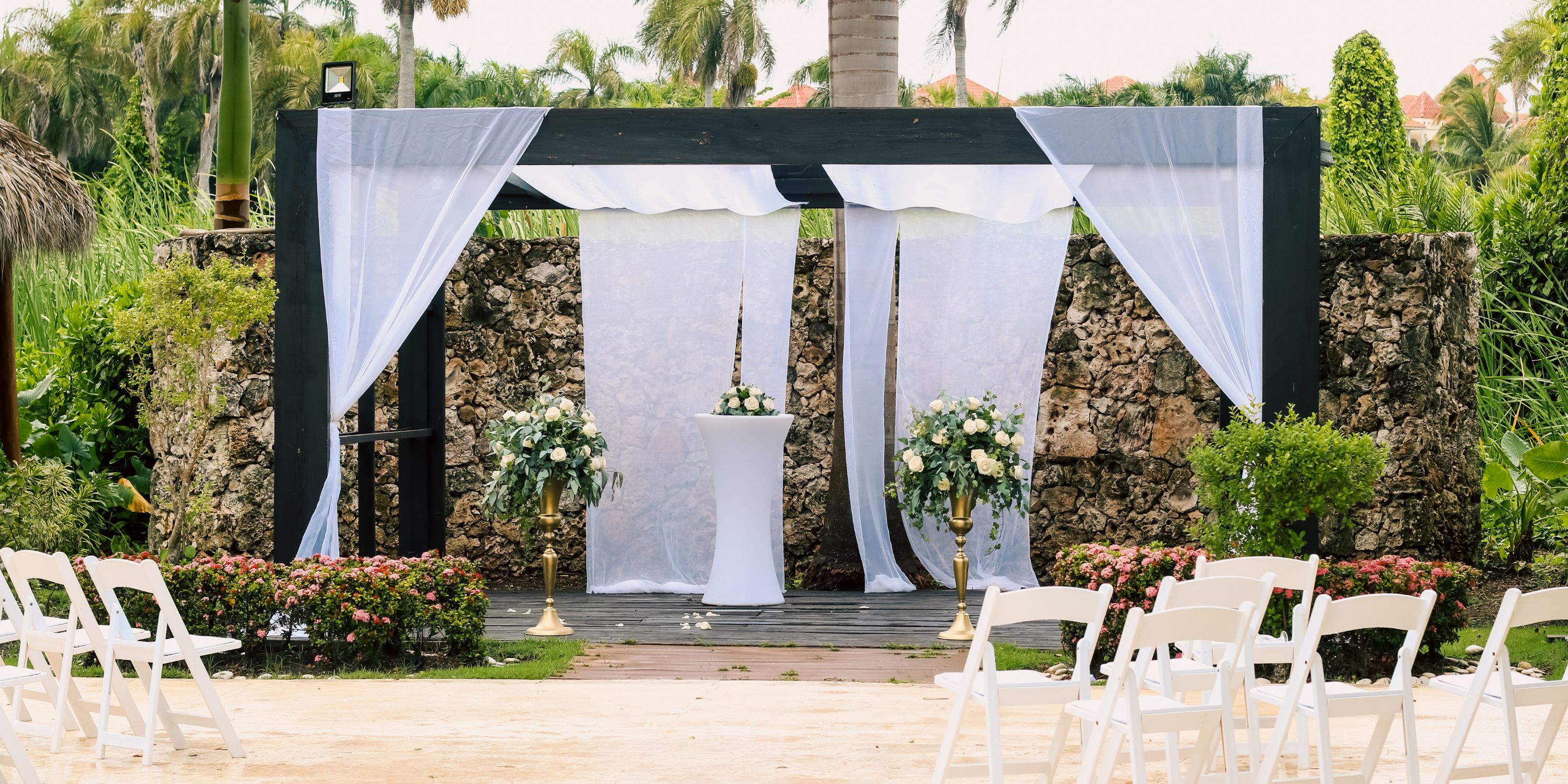 Destination wedding setup at Royalton Splash Punta Cana with white draped altar, flowers, and chairs.