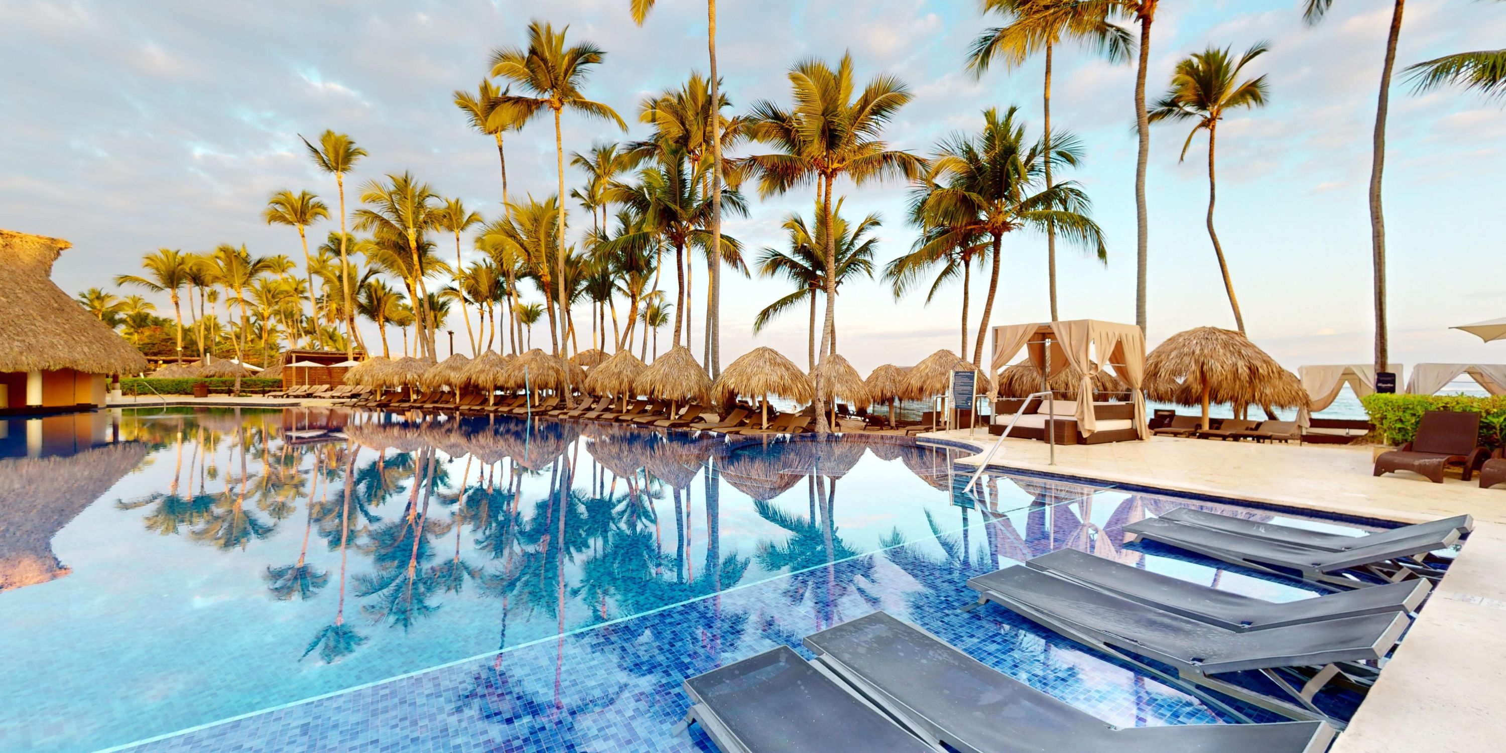 Royalton Splash Punta Cana pool, perfect for a destination wedding, with lounge chairs and palm trees.
