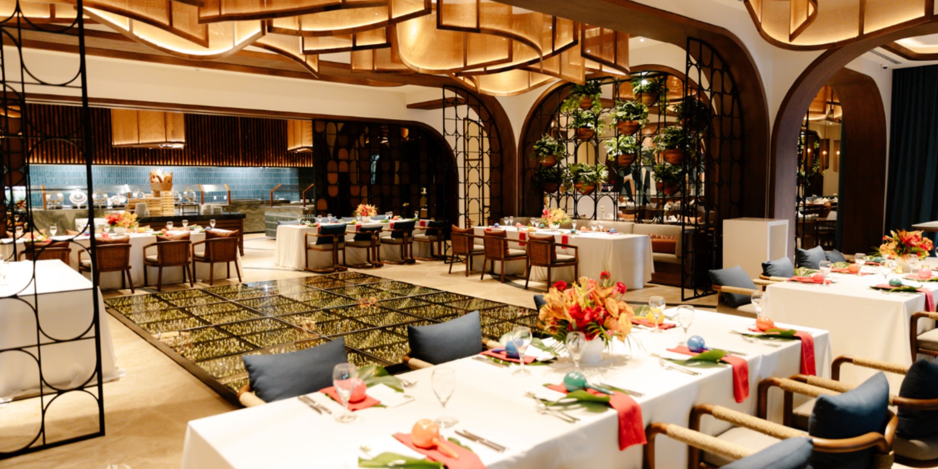 Secrets Maroma Beach: Elegant wedding tables, floral touches, and modern open kitchen ambiance.